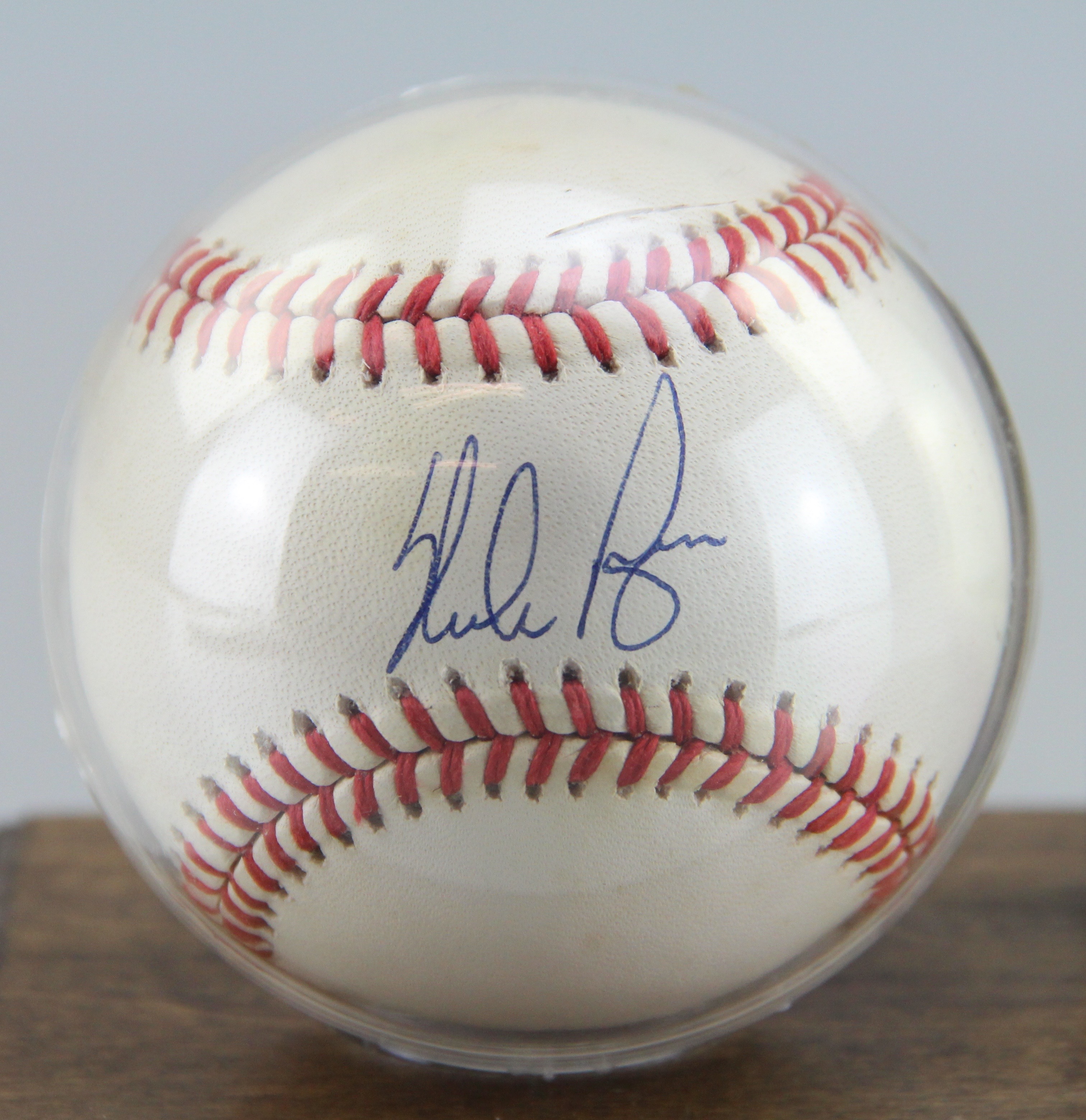 Autographed Nolan Ryan Baseball With Card On Wooden Stand