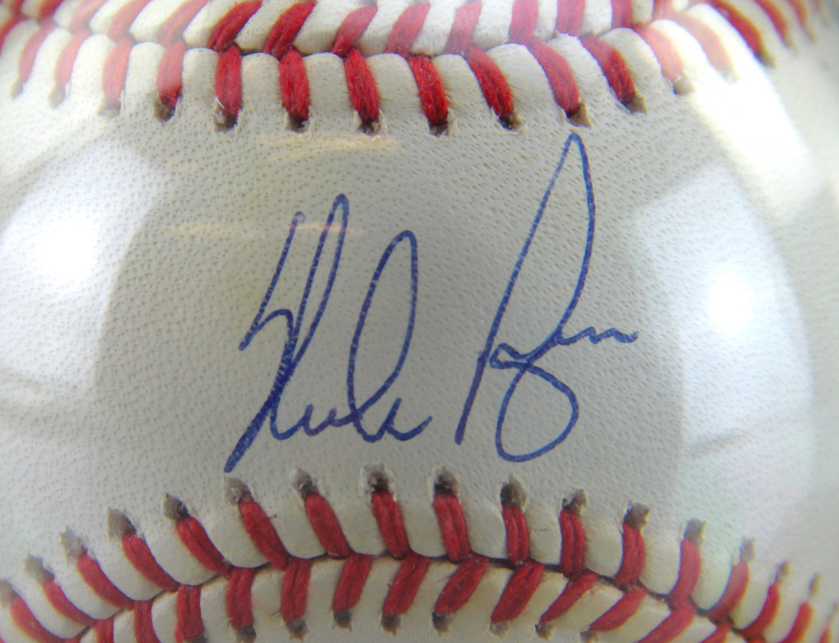 Autographed Nolan Ryan Baseball With Card On Wooden Stand