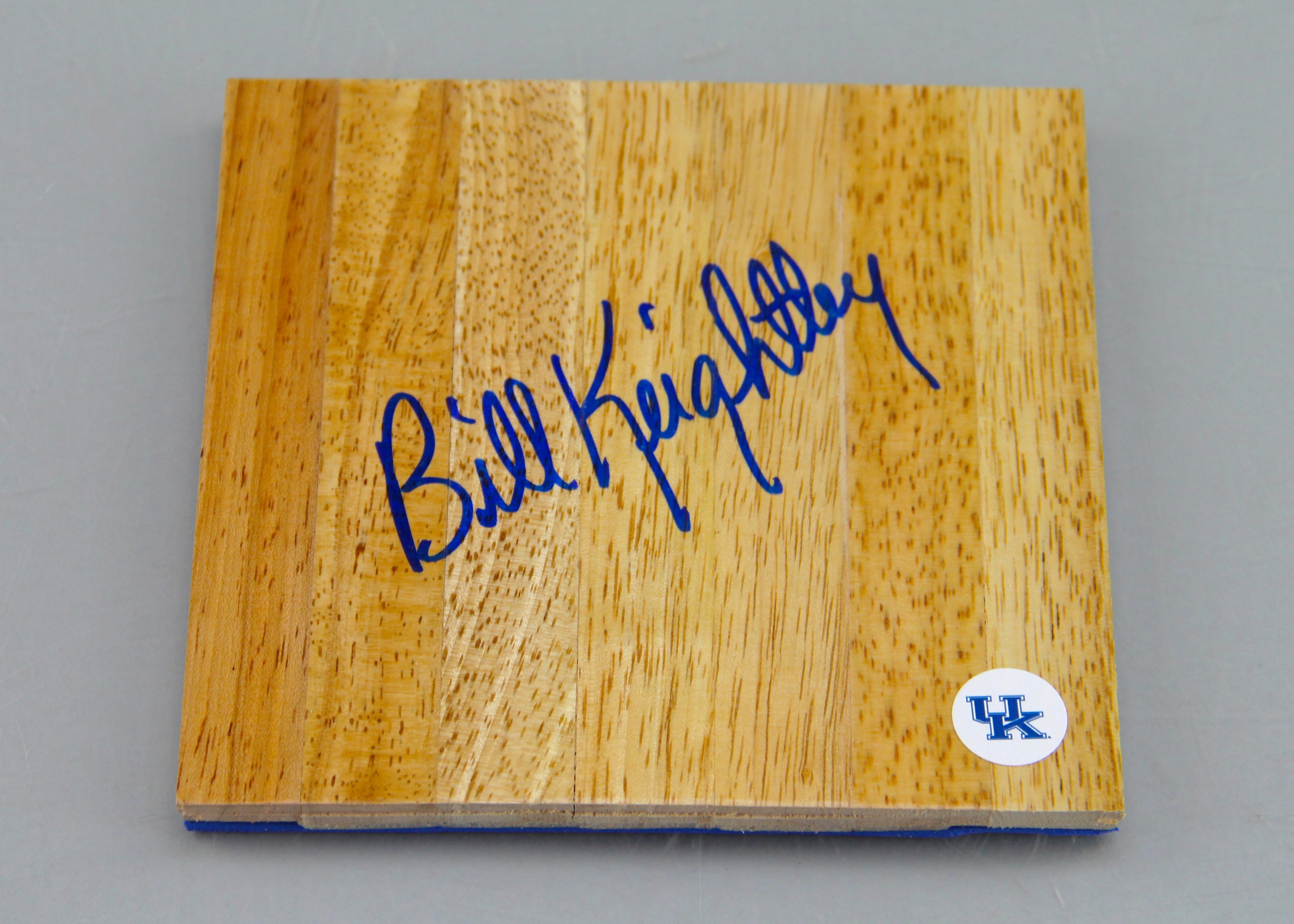 An Autographed Bill Keightley Wood Piece