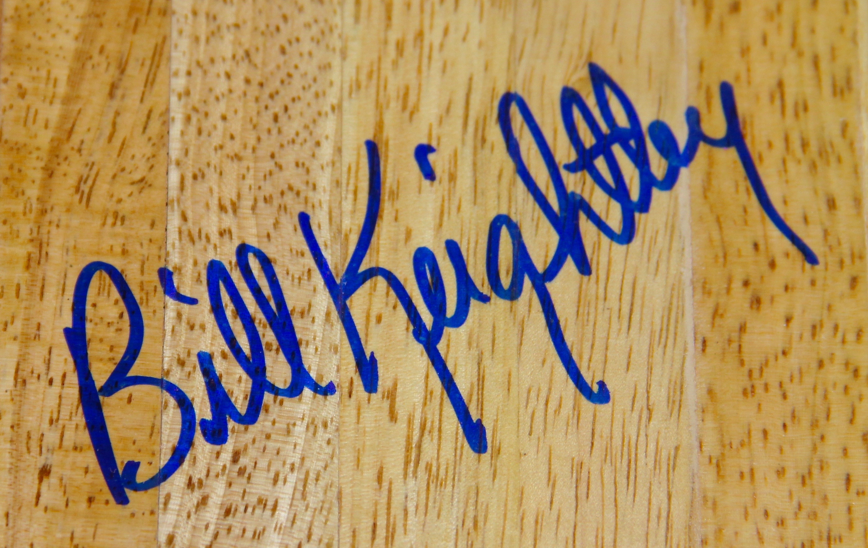 An Autographed Bill Keightley Wood Piece