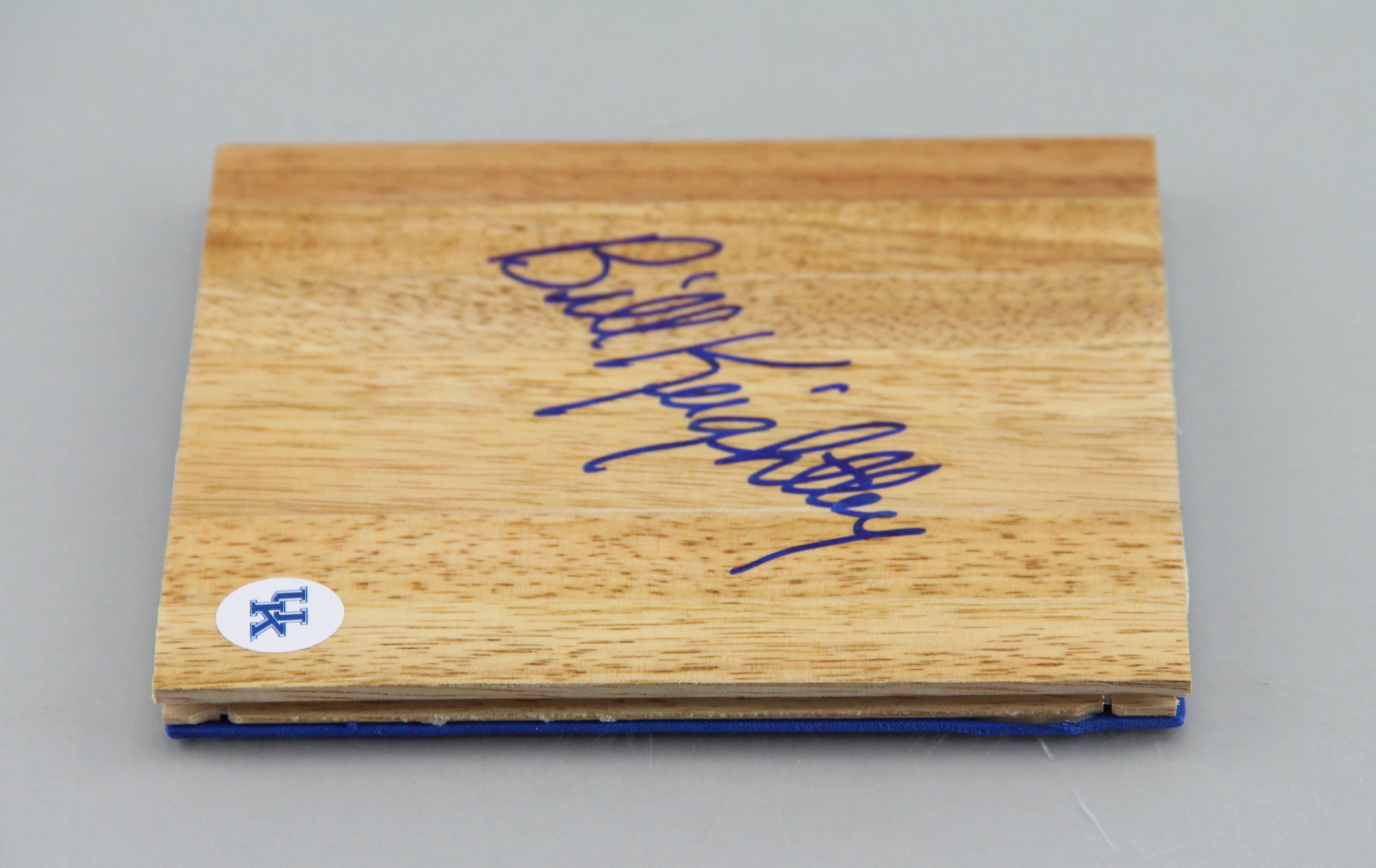 An Autographed Bill Keightley Wood Piece