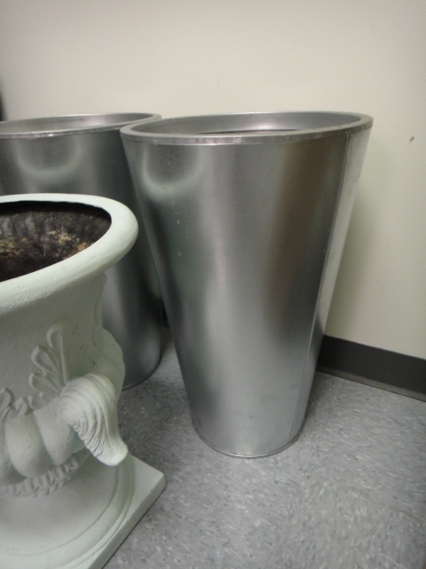 Three Flower Pots and a Trash Can