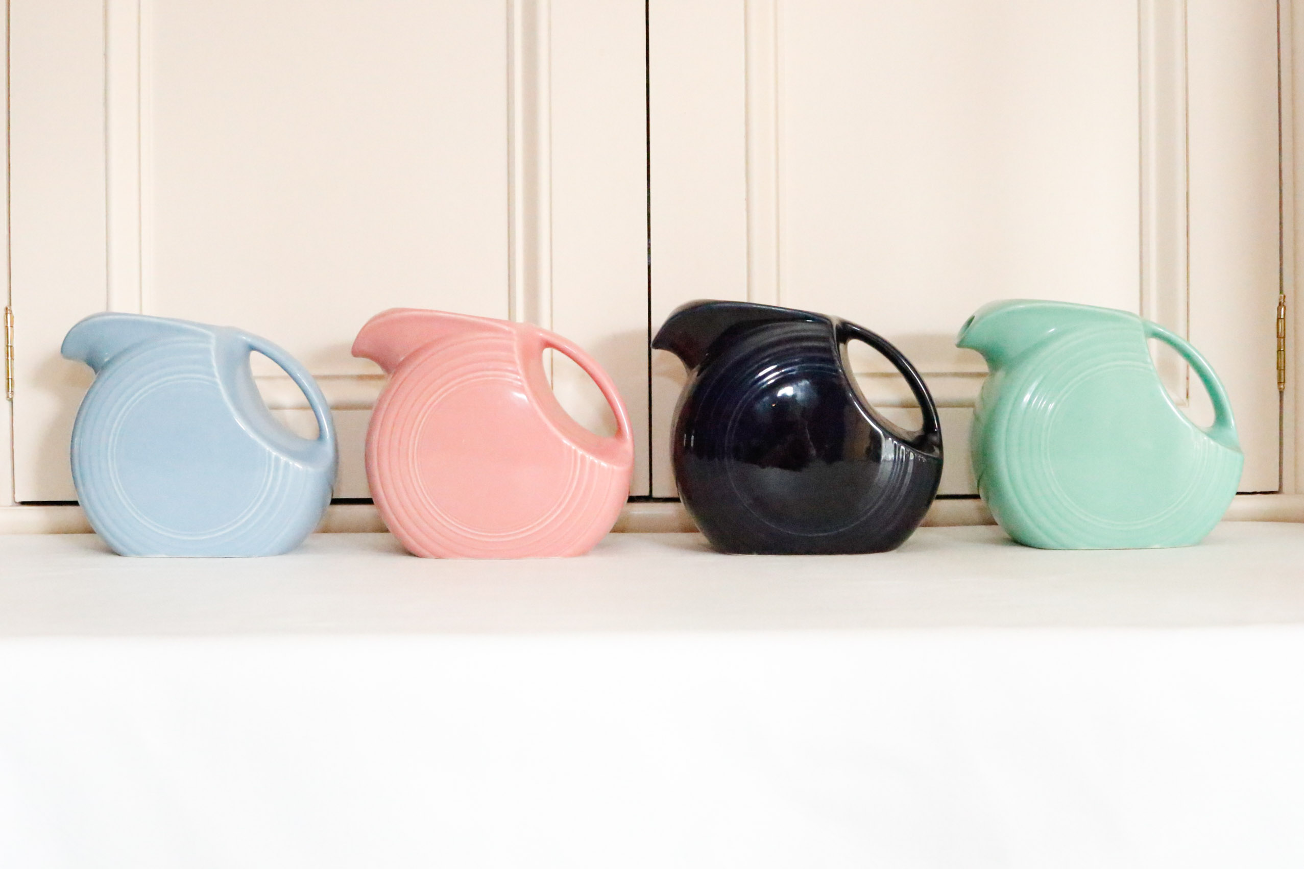 Four Vintage Fiestaware Disc Pitchers in Assorted Colors