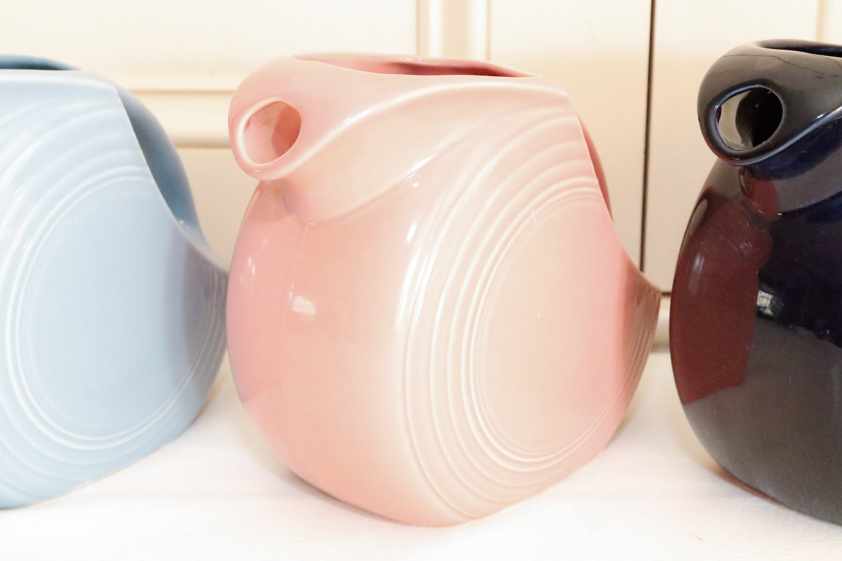 Four Vintage Fiestaware Disc Pitchers in Assorted Colors