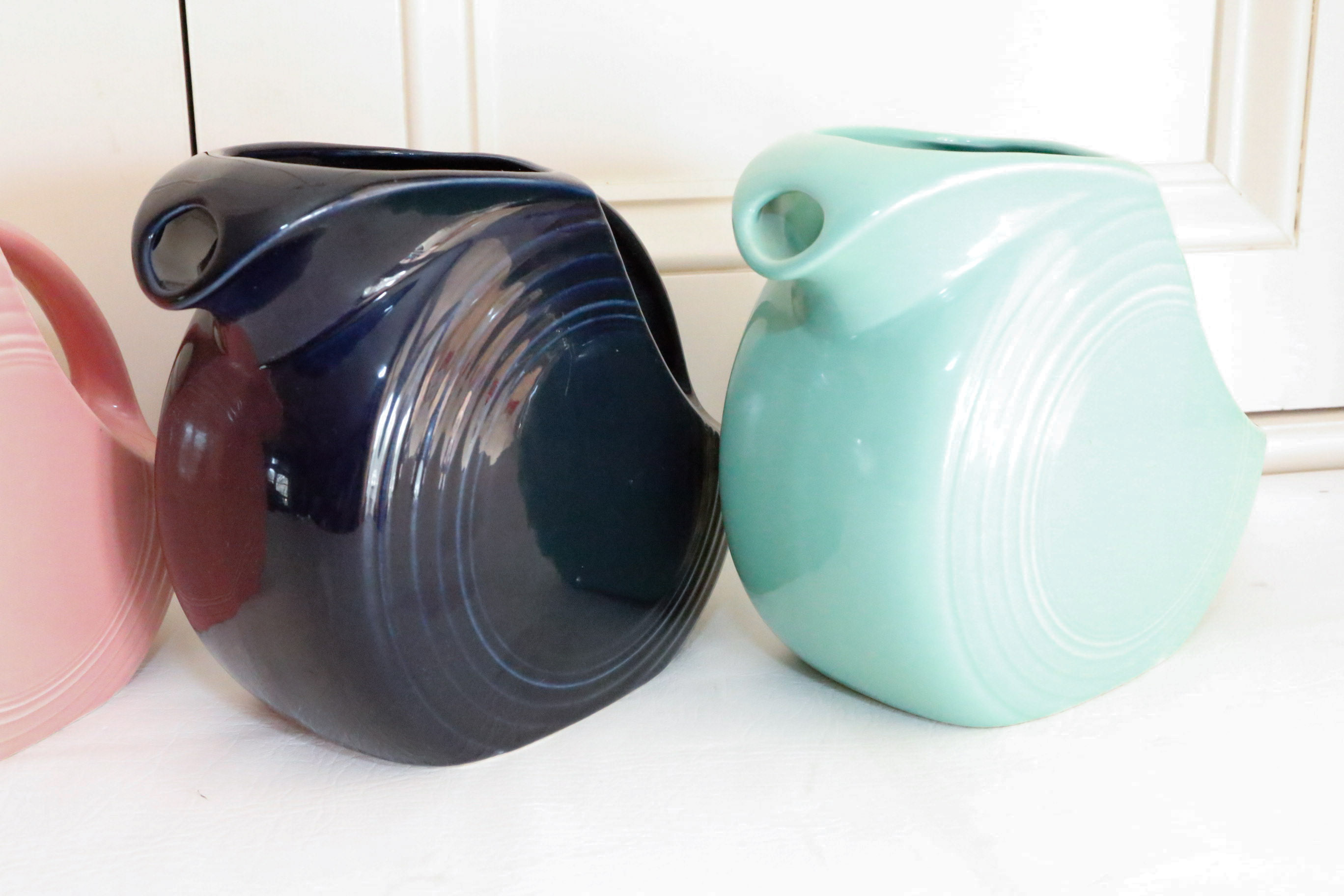 Four Vintage Fiestaware Disc Pitchers in Assorted Colors