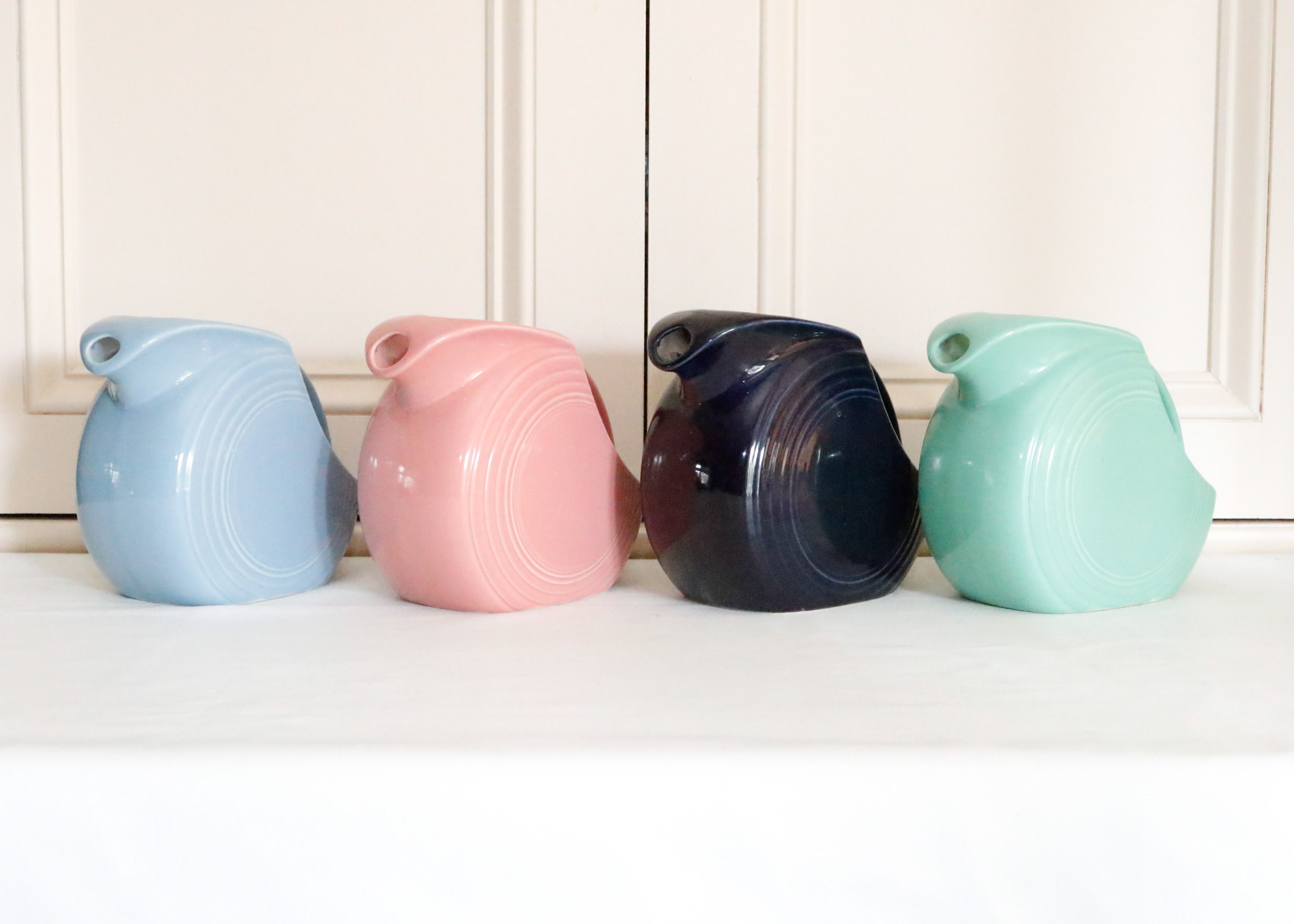 Four Vintage Fiestaware Disc Pitchers in Assorted Colors