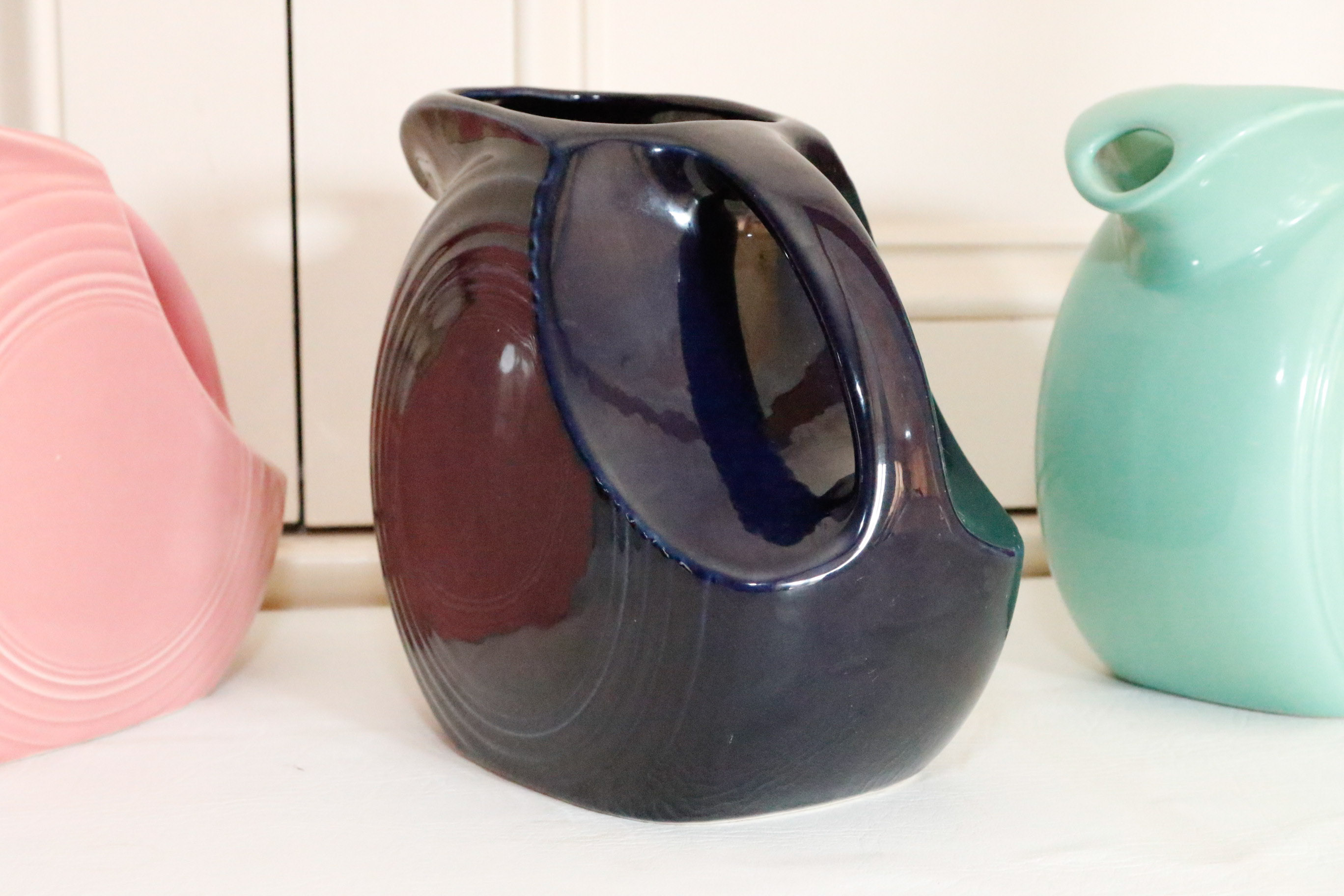 Four Vintage Fiestaware Disc Pitchers in Assorted Colors