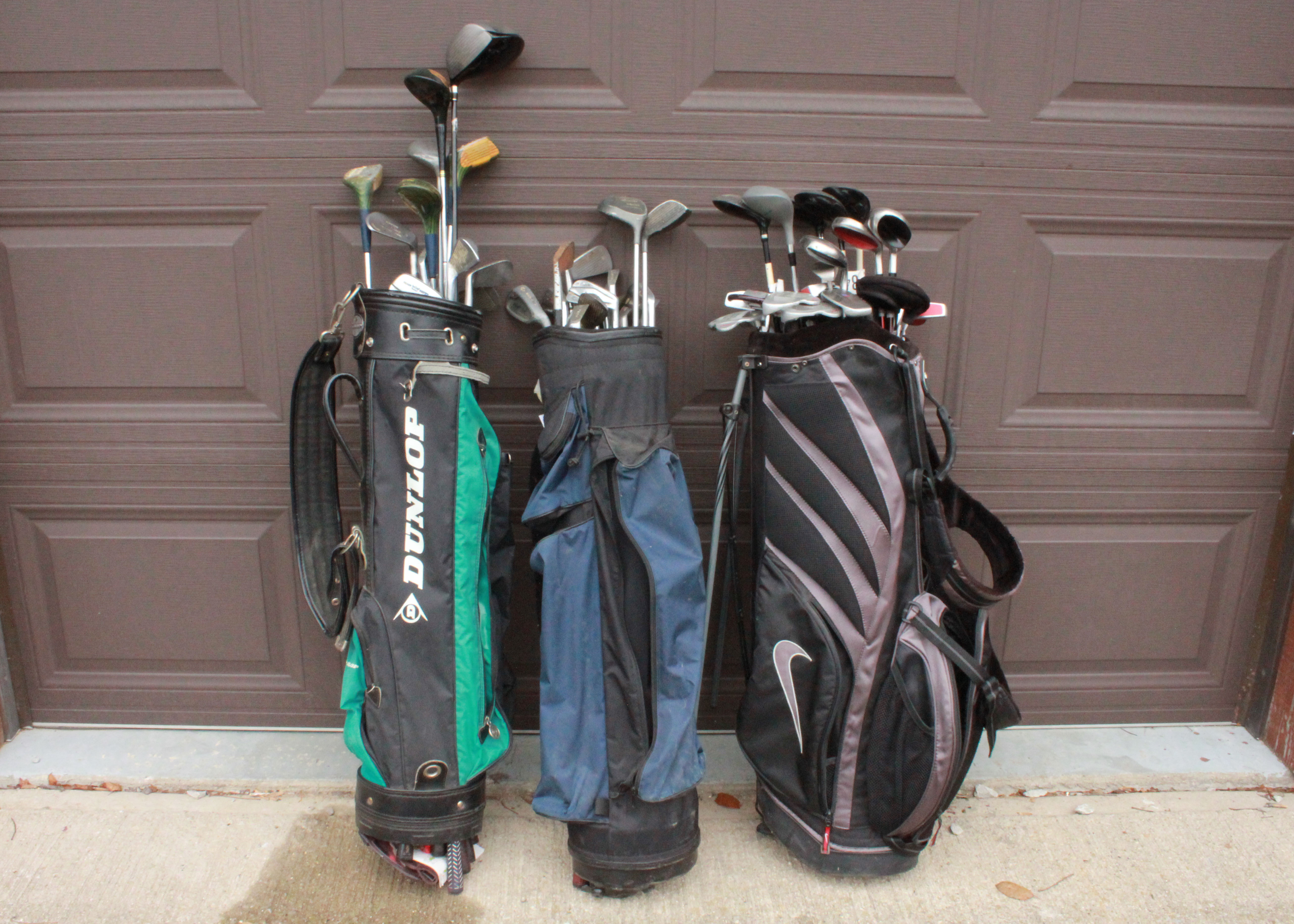 Collection of Assorted Golf Clubs and Bags