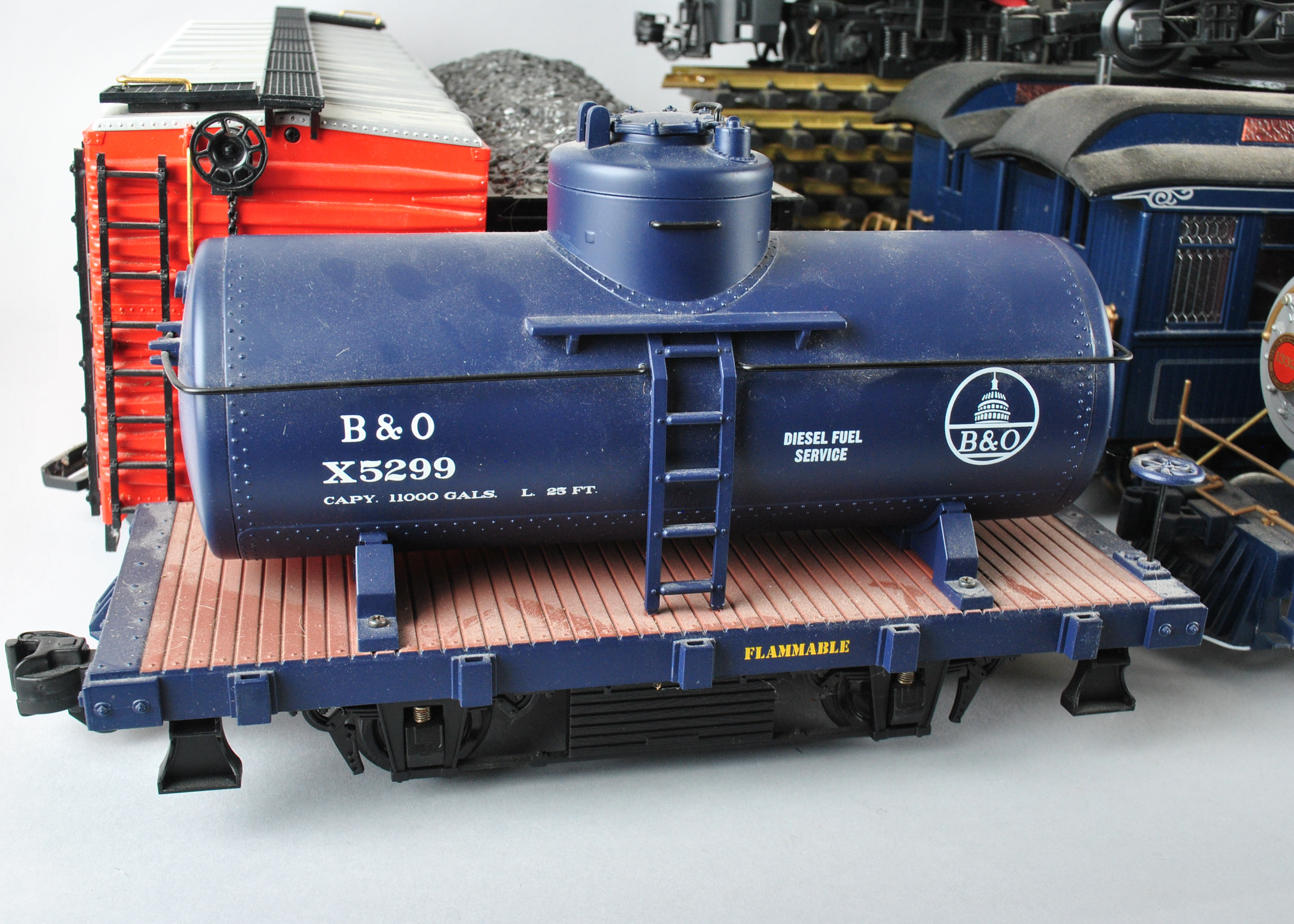 Assortment Of G-Scale Freight Cars, Tracks, And Accessories