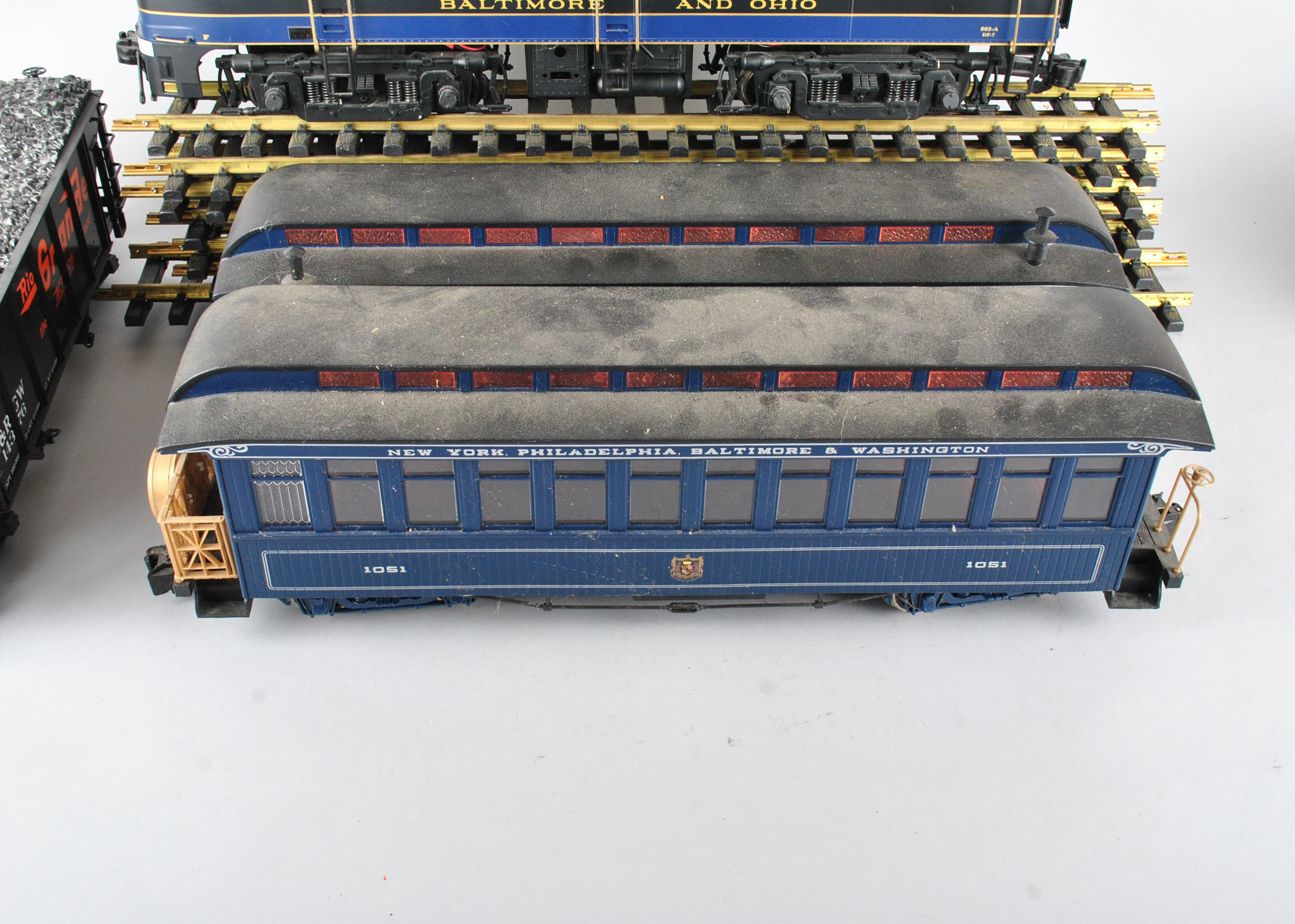 Assortment Of G-Scale Freight Cars, Tracks, And Accessories