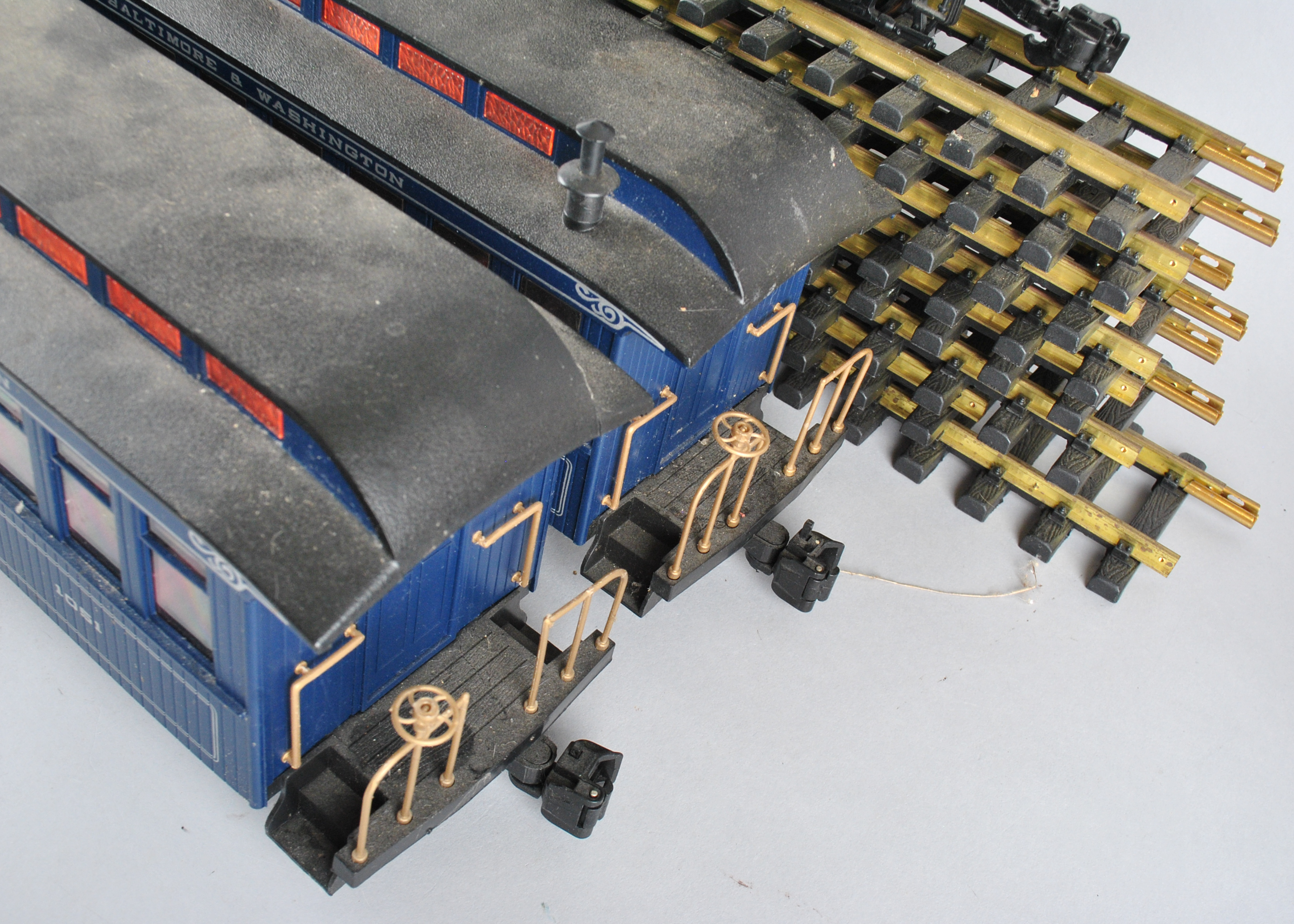 Assortment Of G-Scale Freight Cars, Tracks, And Accessories