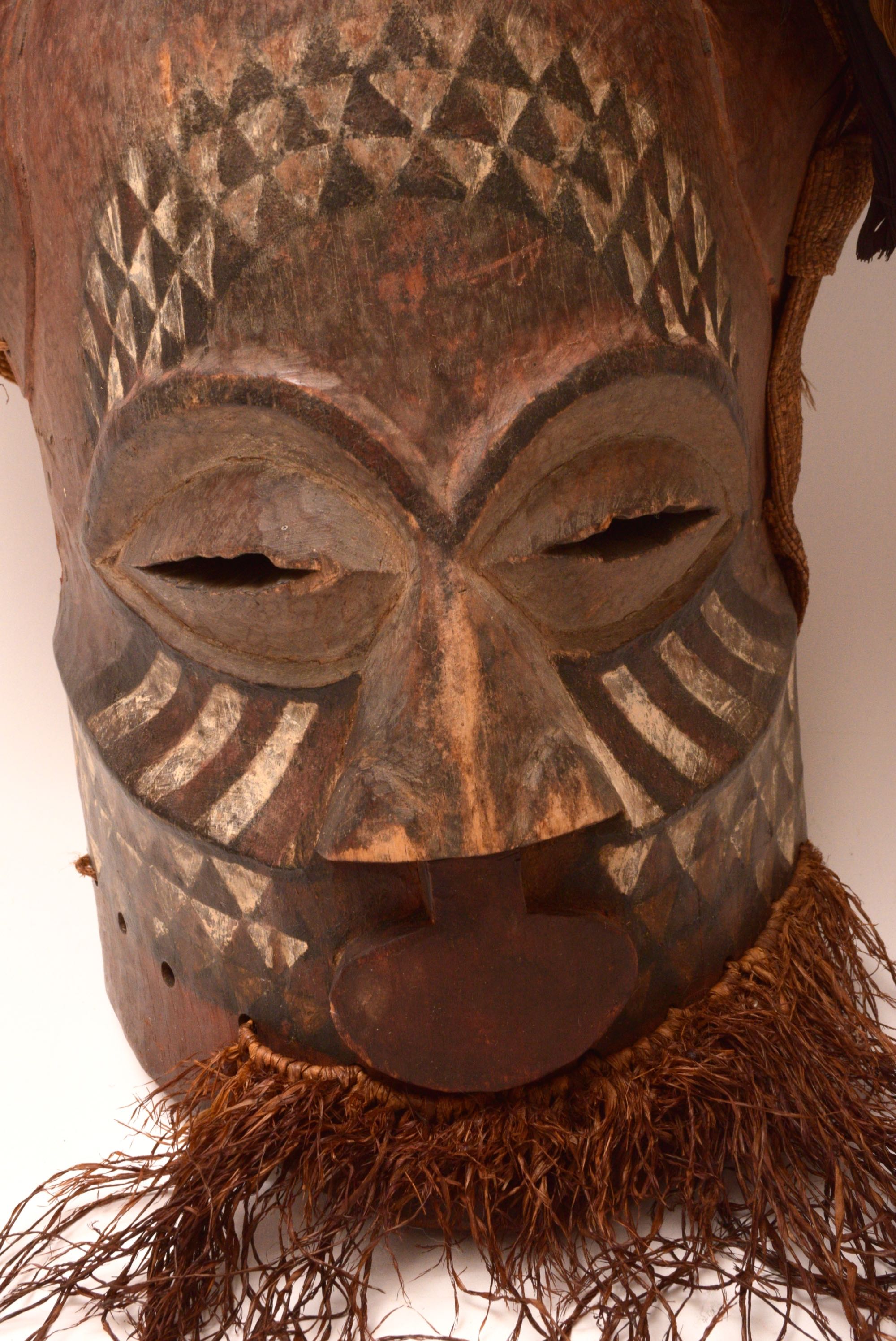 Handcrafted African Wooden Tribal Mask with Feathers