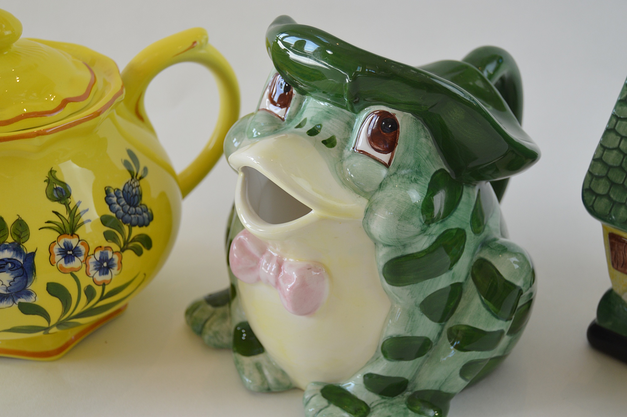 Three Ceramic Teapots, with a Yellow Tiffany Pot