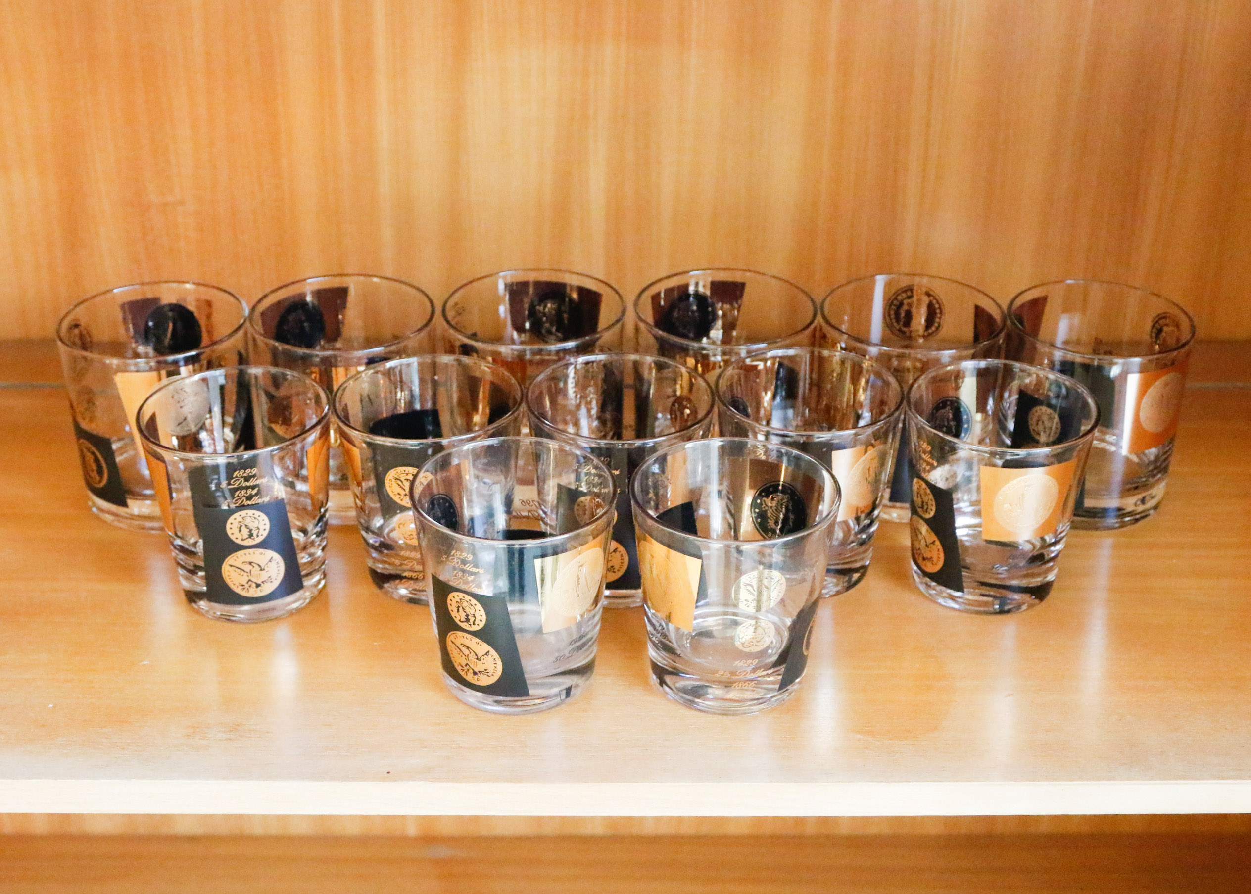 Set of Twelve Vintage Black and Gold U.S. Coin Theme Tumblers