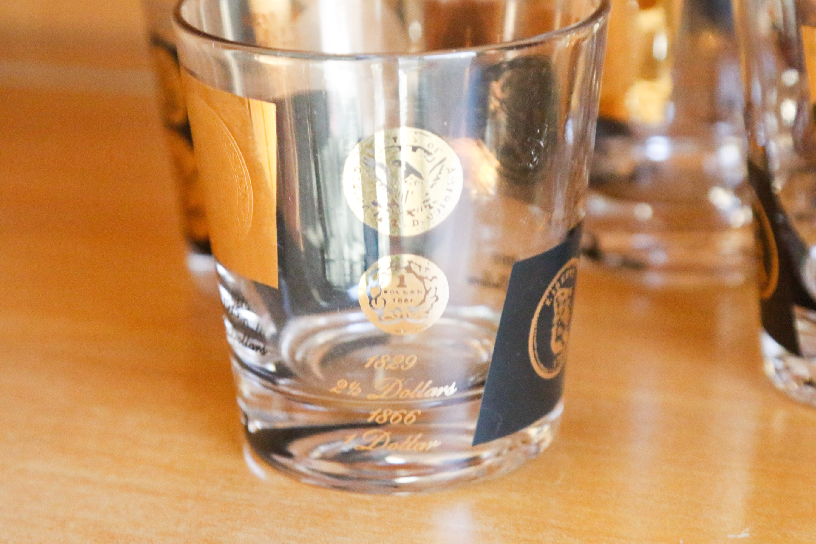 Set of Twelve Vintage Black and Gold U.S. Coin Theme Tumblers