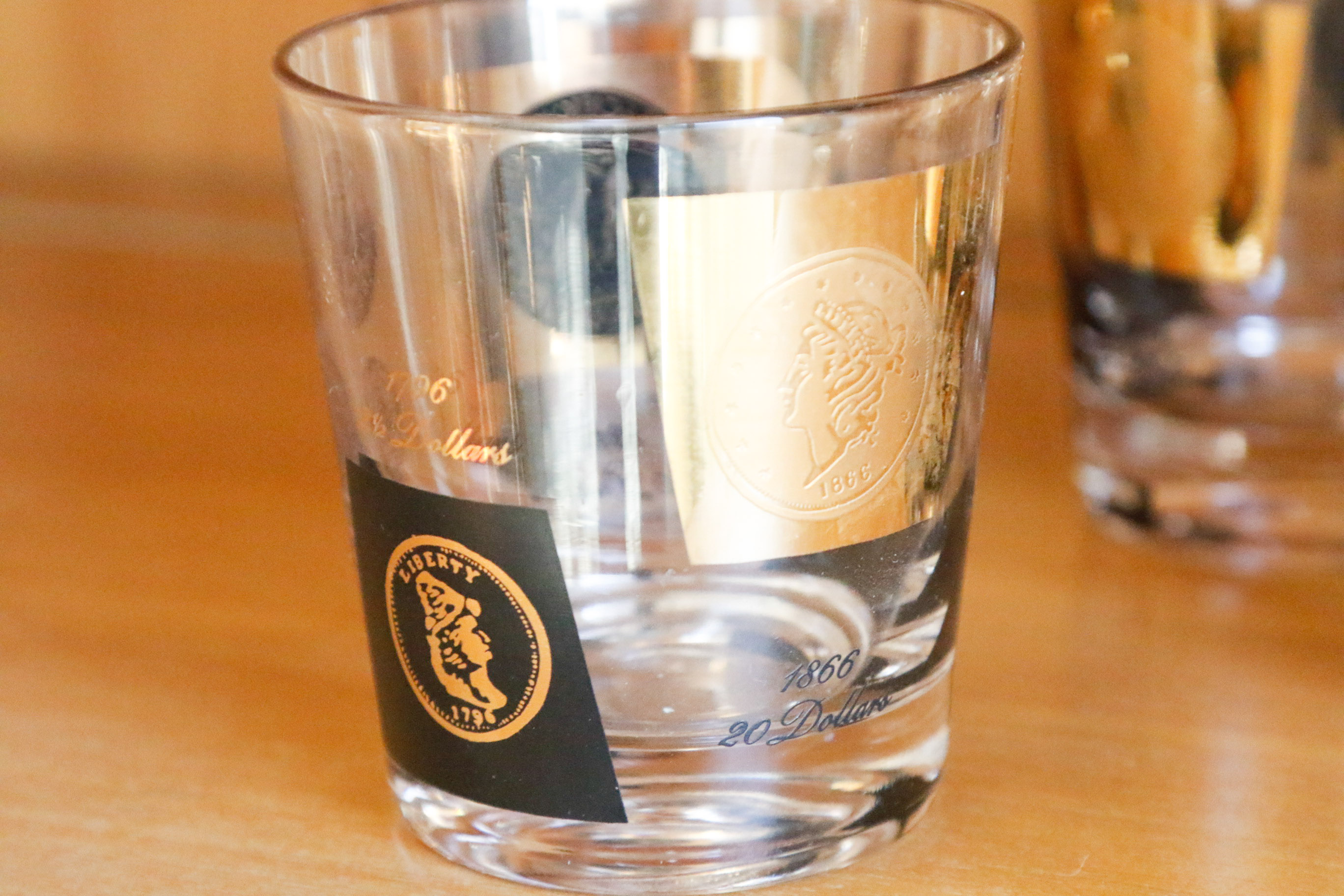 Set of Twelve Vintage Black and Gold U.S. Coin Theme Tumblers