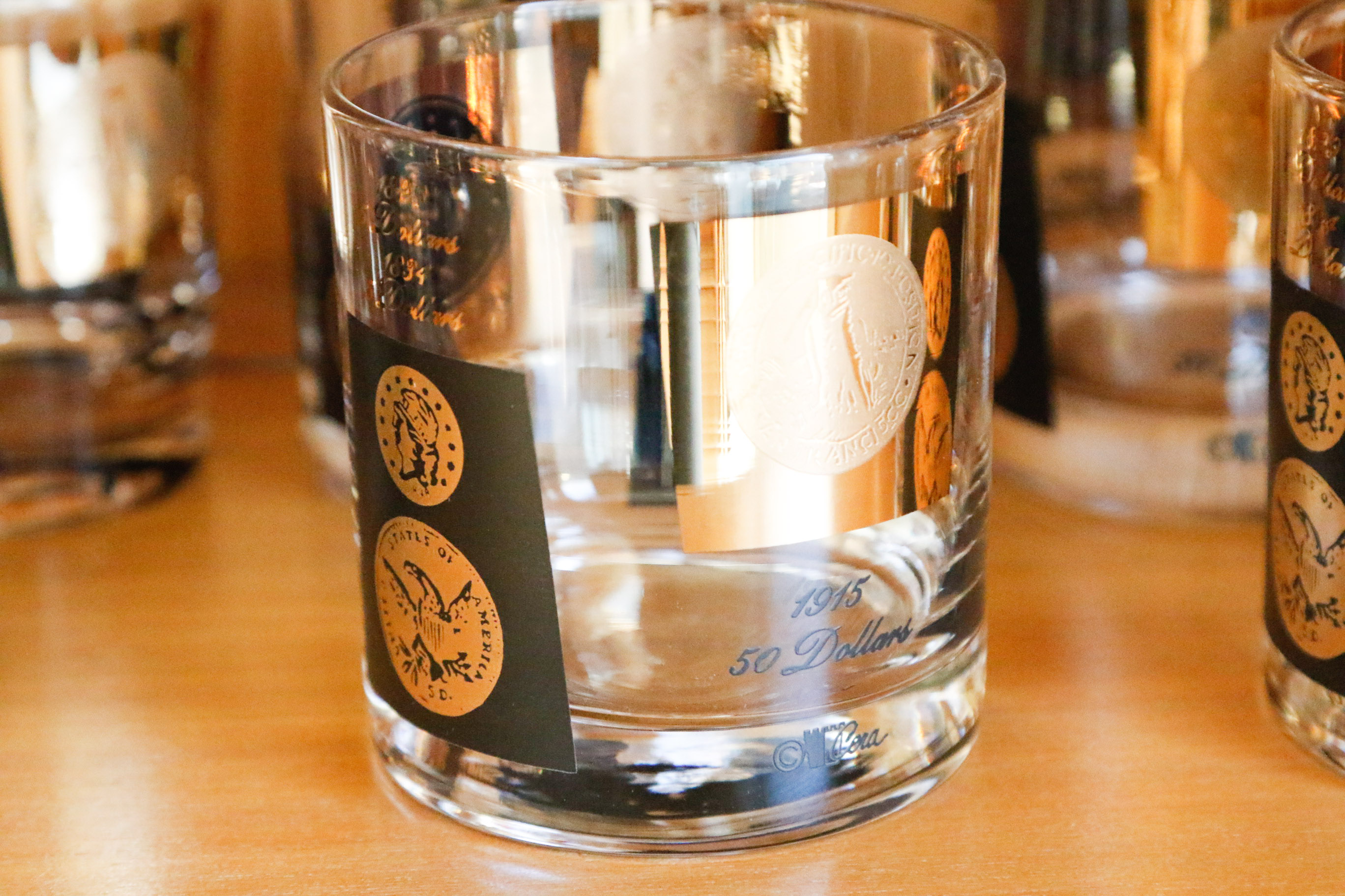 Set of Twelve Vintage Black and Gold U.S. Coin Theme Tumblers