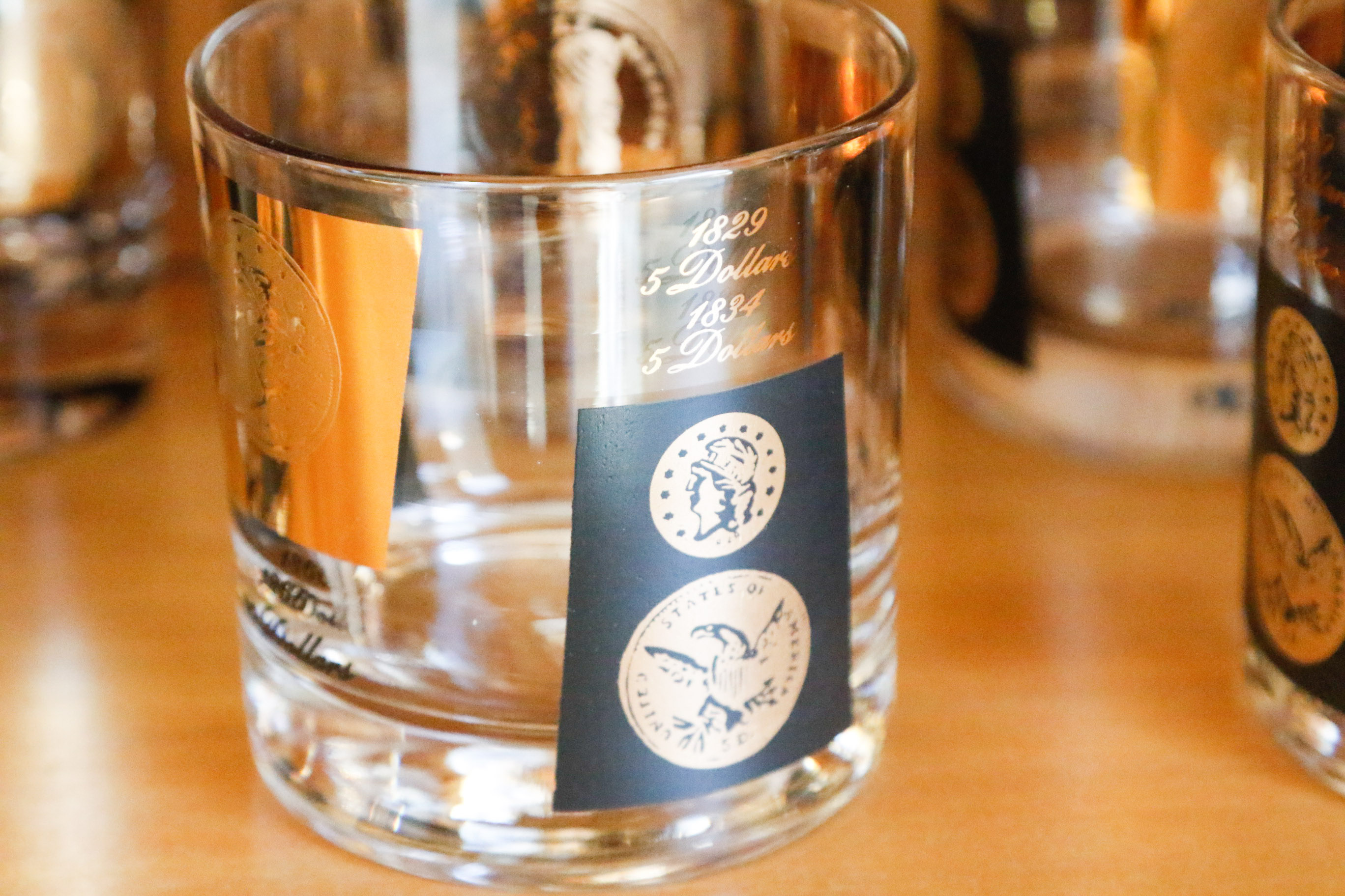 Set of Twelve Vintage Black and Gold U.S. Coin Theme Tumblers