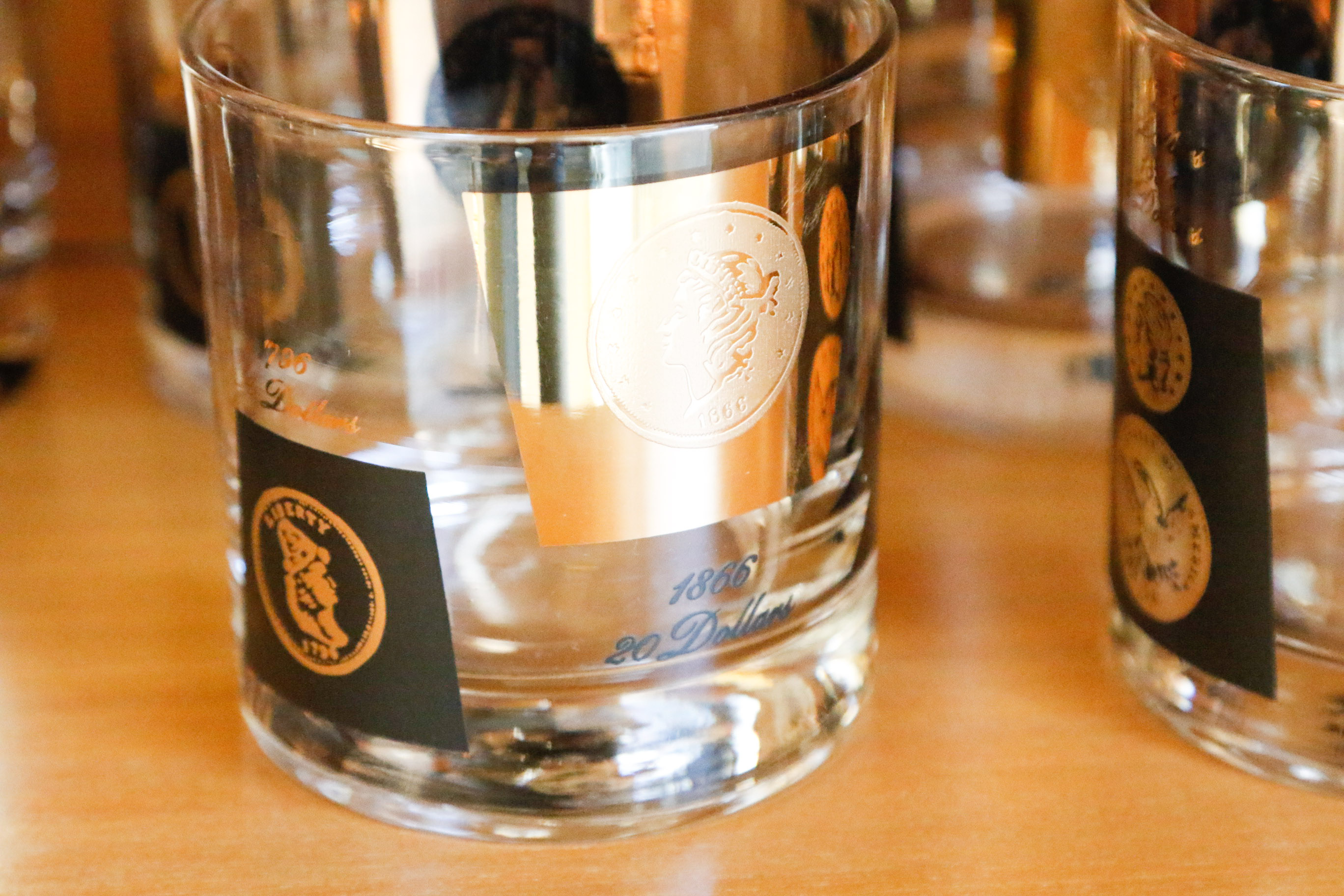 Set of Twelve Vintage Black and Gold U.S. Coin Theme Tumblers