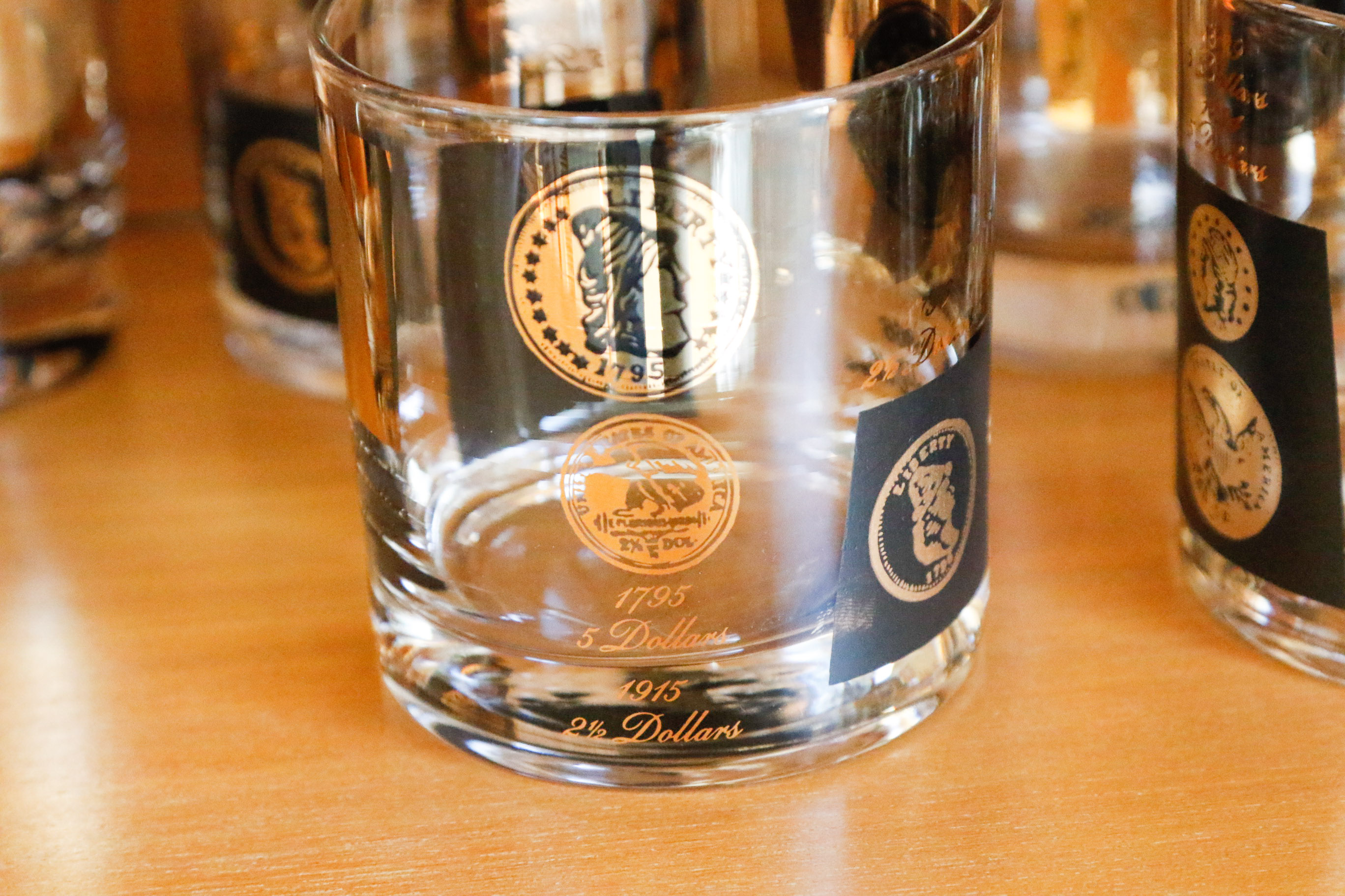 Set of Twelve Vintage Black and Gold U.S. Coin Theme Tumblers