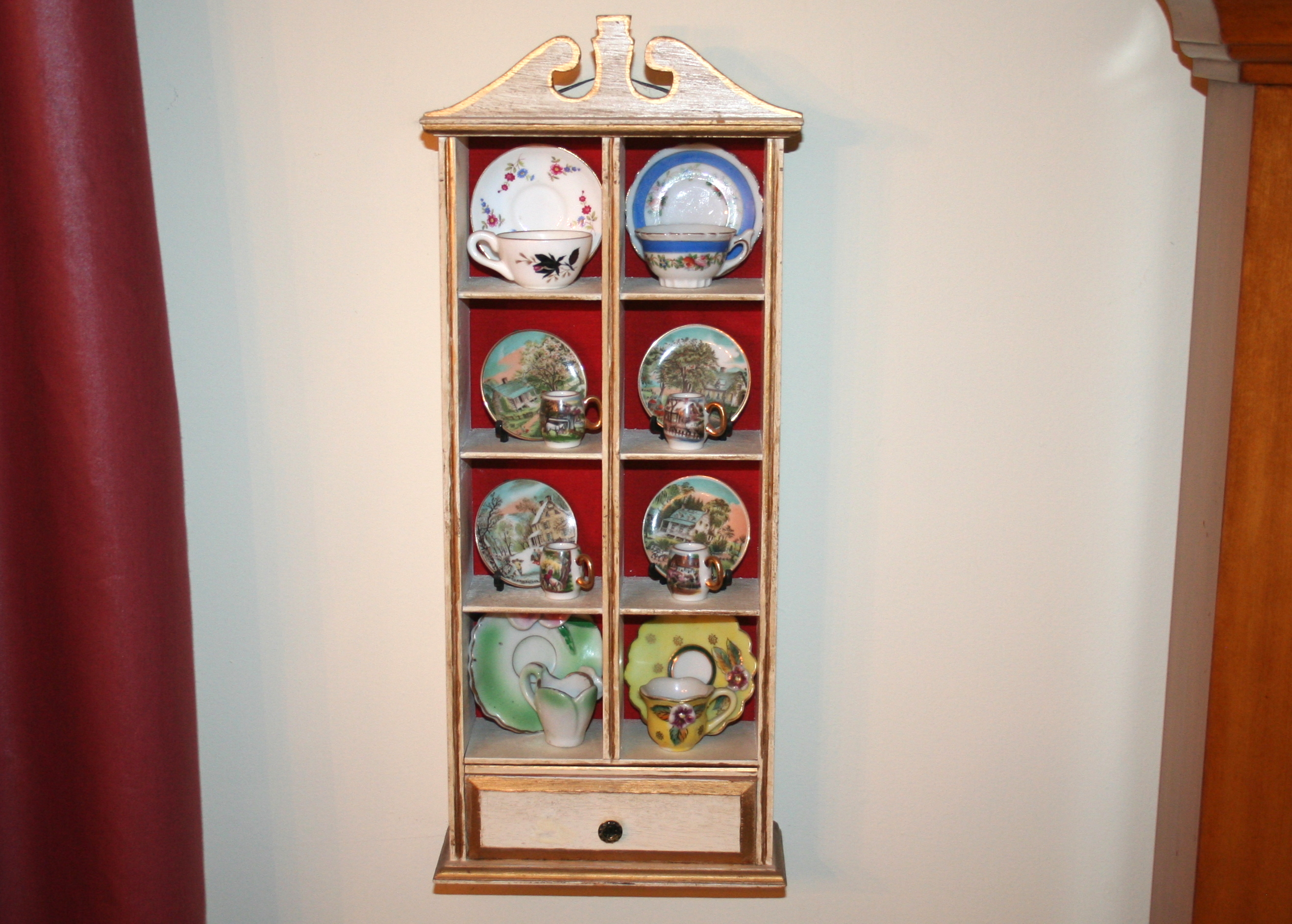 Miniature Cups and Saucers in Small Display Cabinet