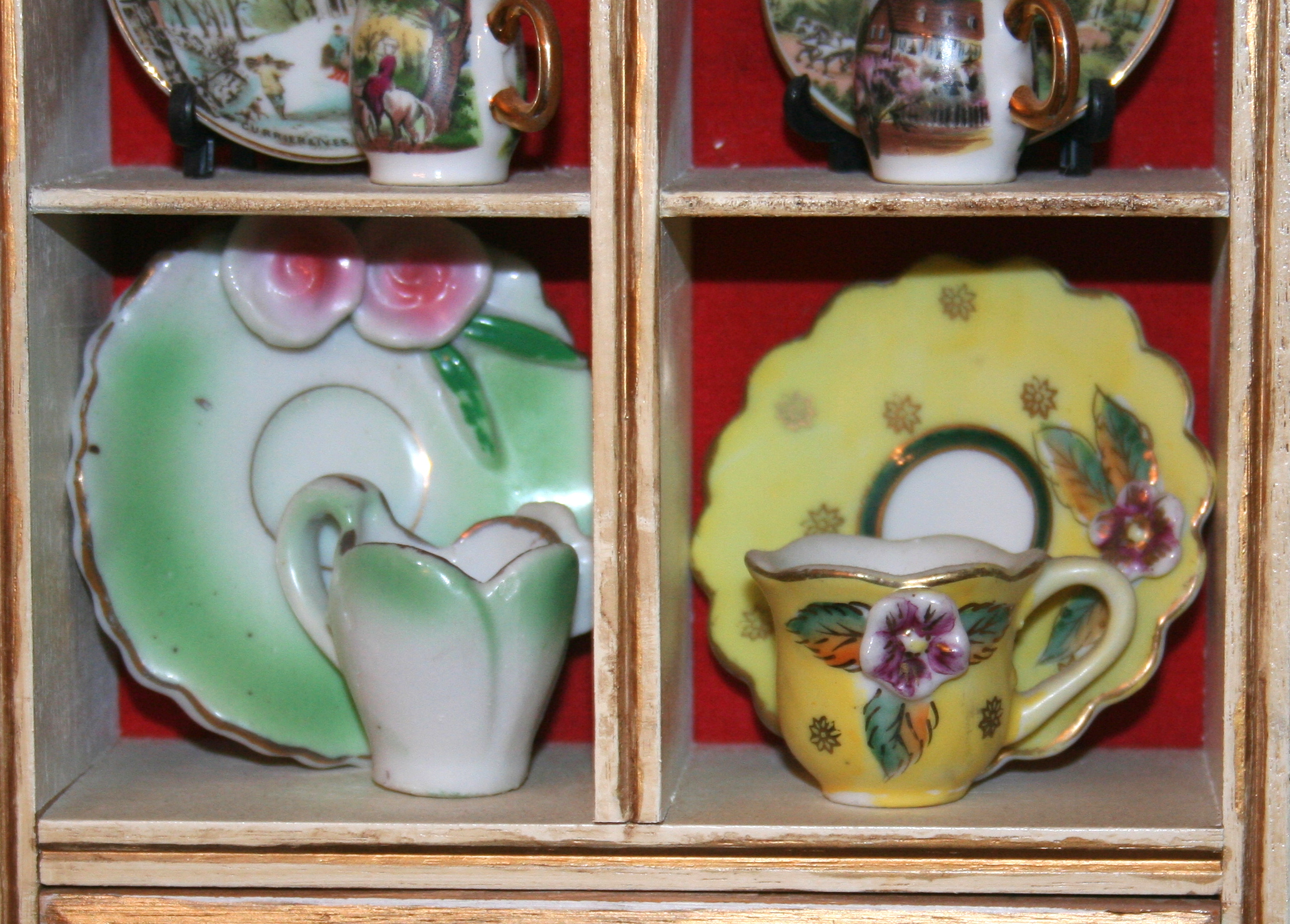 Miniature Cups and Saucers in Small Display Cabinet
