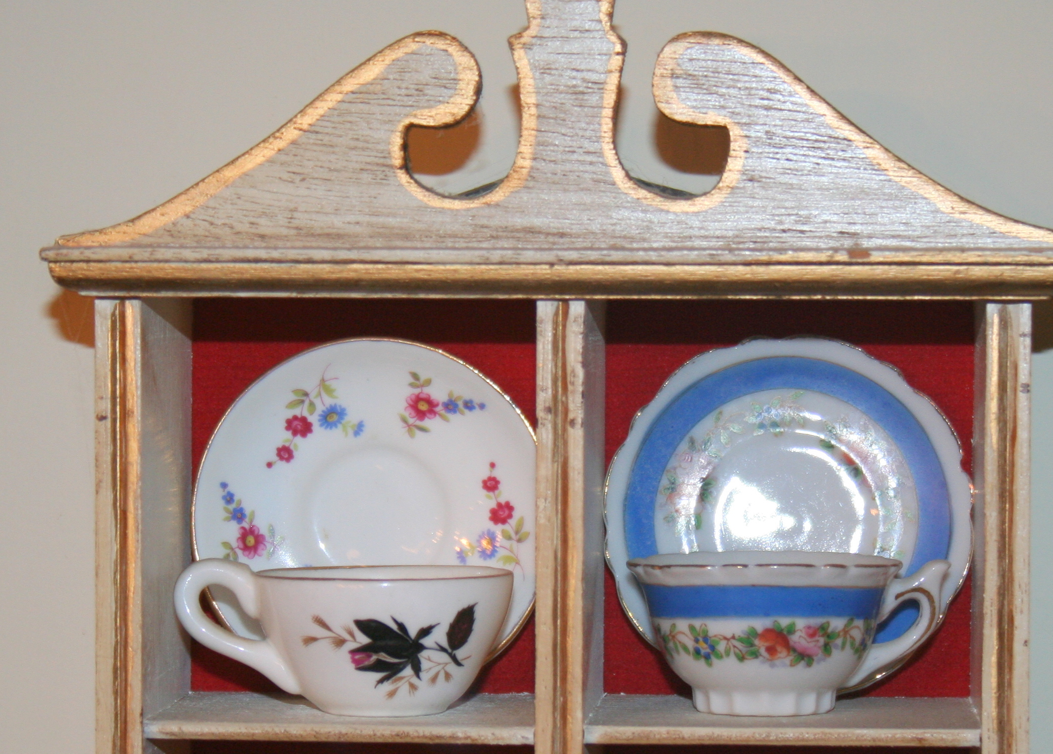 Miniature Cups and Saucers in Small Display Cabinet