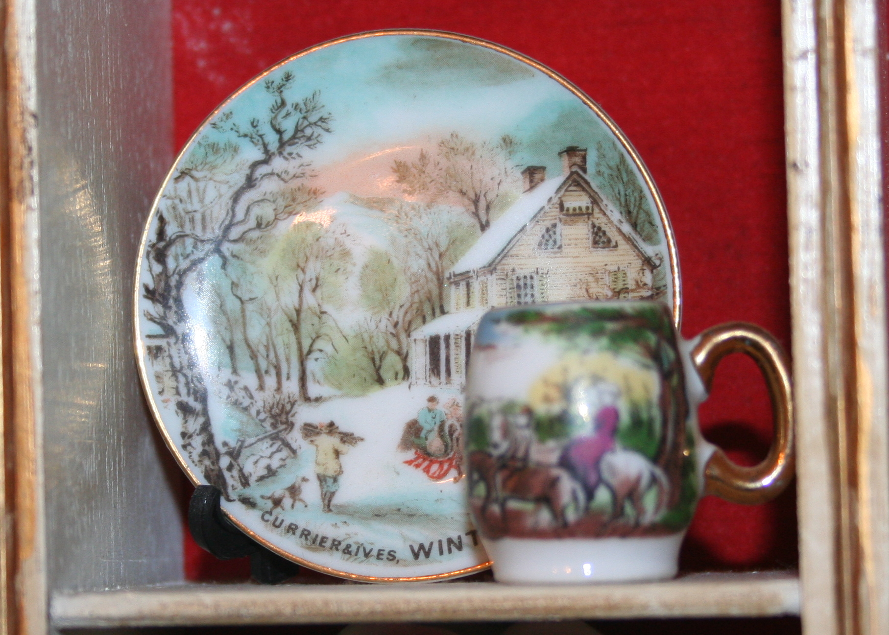 Miniature Cups and Saucers in Small Display Cabinet