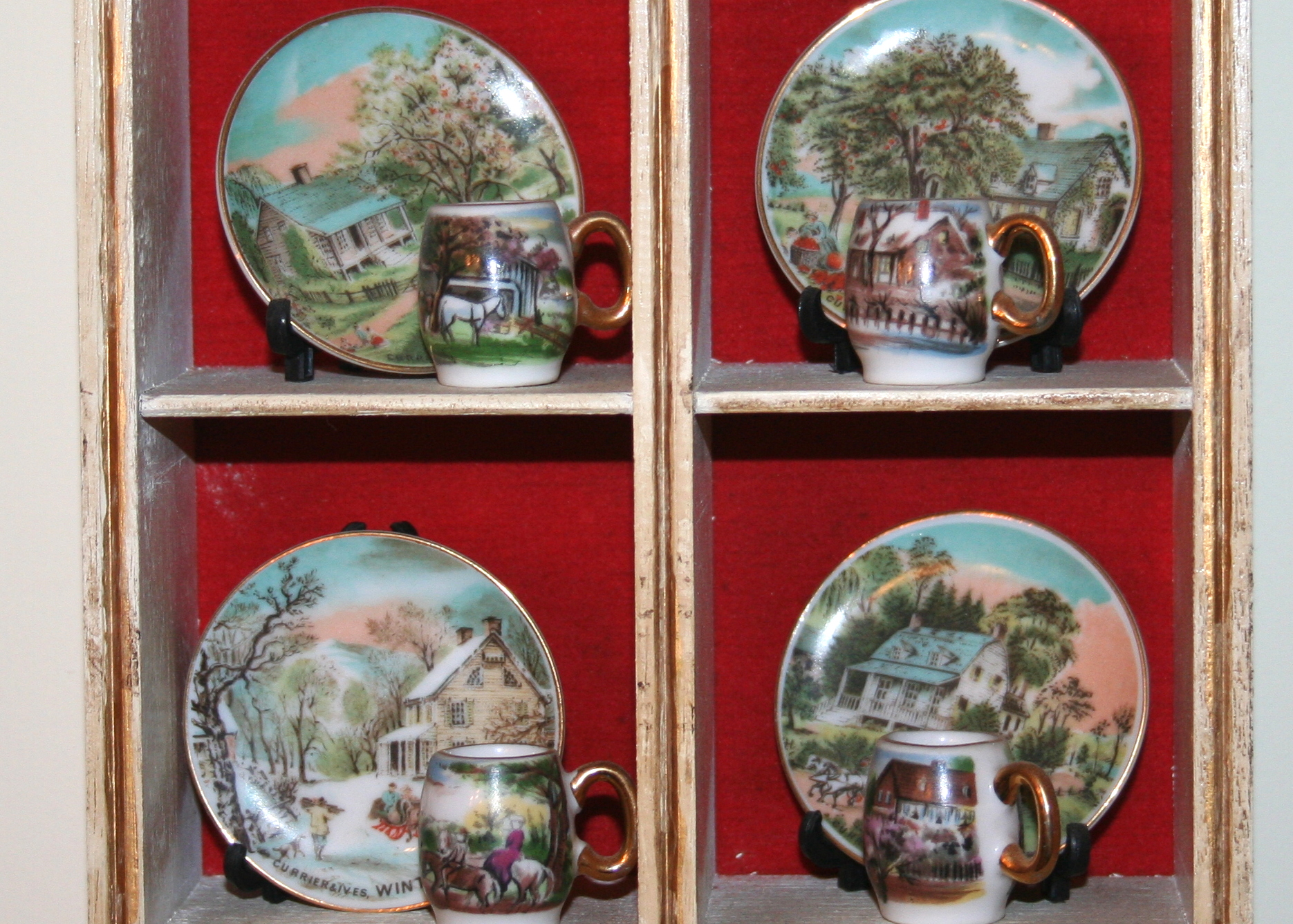 Miniature Cups and Saucers in Small Display Cabinet