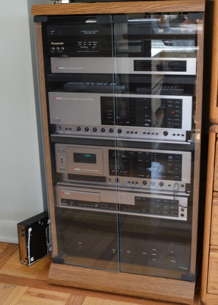 Kyocera Stereo System, Panasonic VHS/DVD and Laminate Cabinet