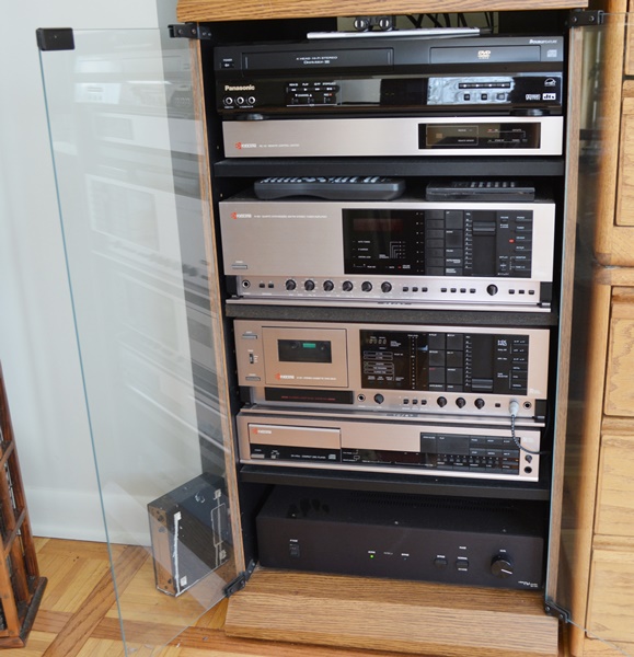 Kyocera Stereo System, Panasonic VHS/DVD and Laminate Cabinet
