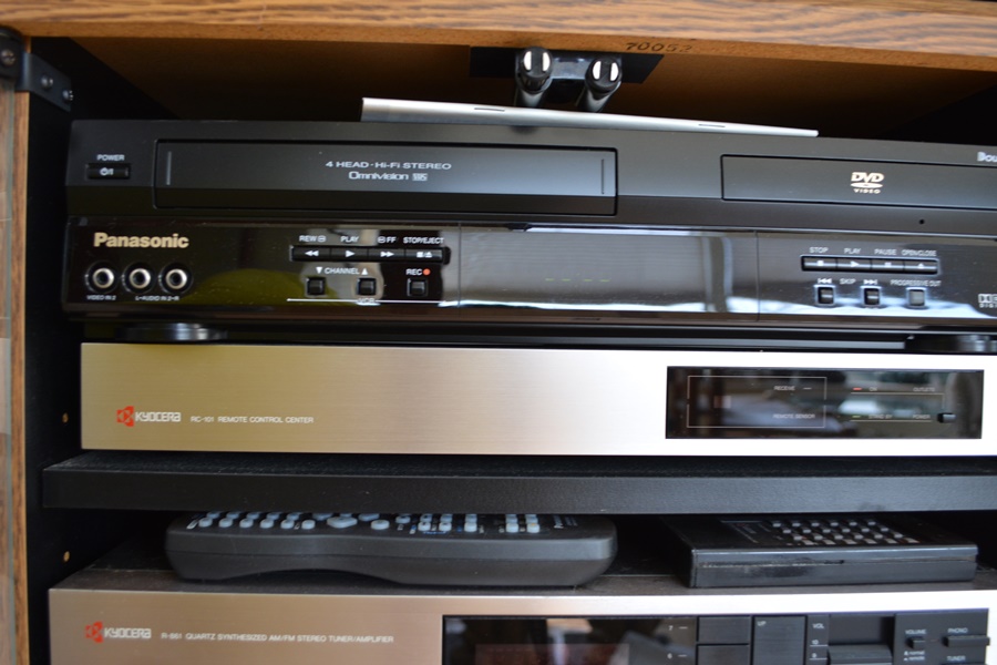 Kyocera Stereo System, Panasonic VHS/DVD and Laminate Cabinet