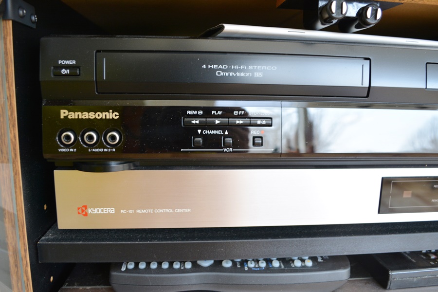 Kyocera Stereo System, Panasonic VHS/DVD and Laminate Cabinet