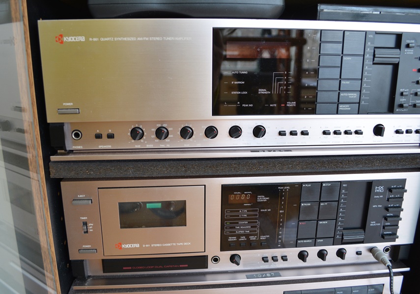 Kyocera Stereo System, Panasonic VHS/DVD and Laminate Cabinet