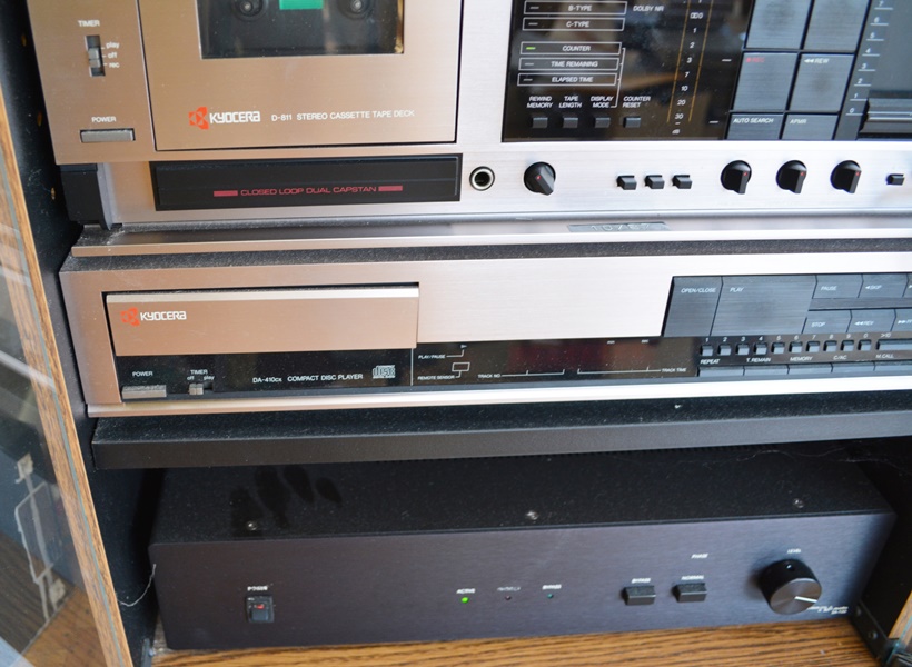 Kyocera Stereo System, Panasonic VHS/DVD and Laminate Cabinet