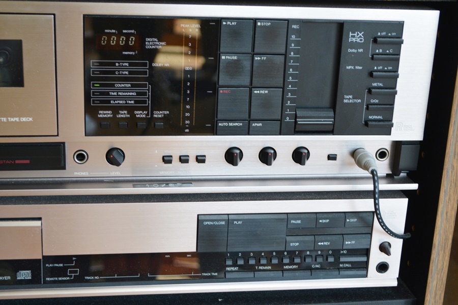 Kyocera Stereo System, Panasonic VHS/DVD and Laminate Cabinet