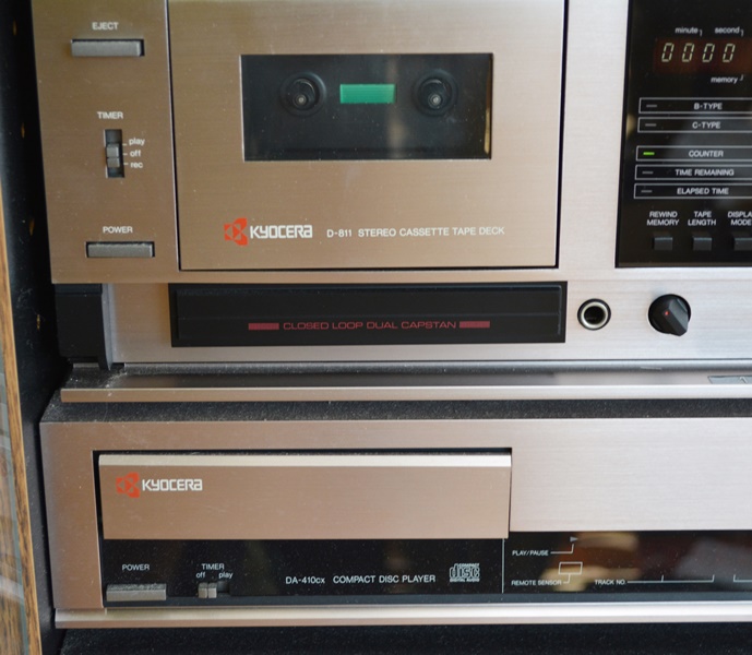 Kyocera Stereo System, Panasonic VHS/DVD and Laminate Cabinet