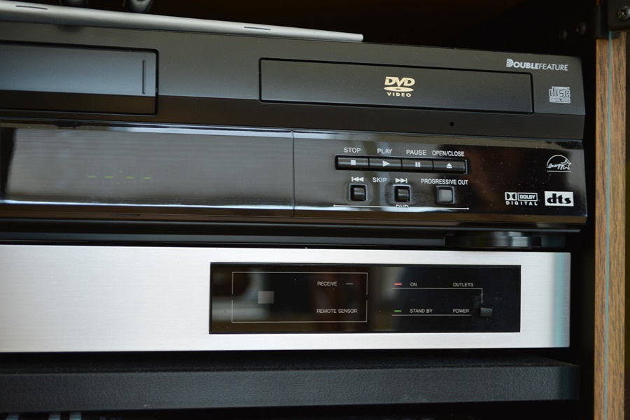 Kyocera Stereo System, Panasonic VHS/DVD and Laminate Cabinet