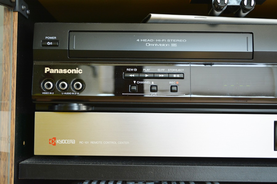 Kyocera Stereo System, Panasonic VHS/DVD and Laminate Cabinet
