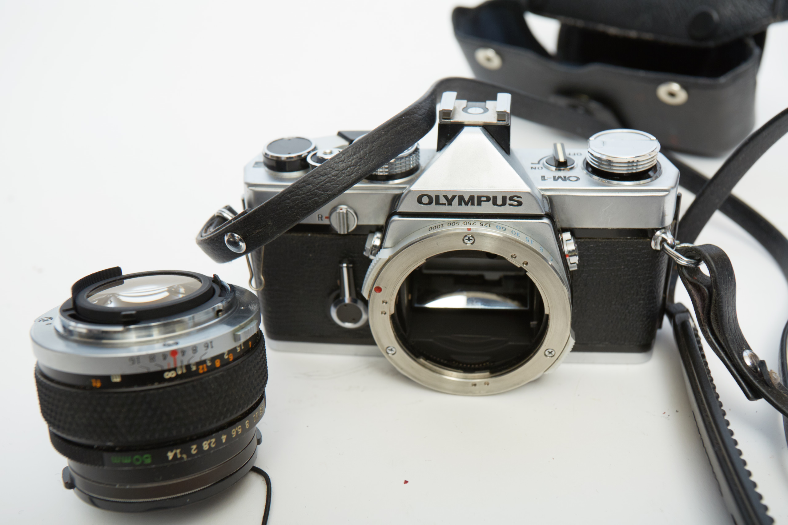 Vintage Olympus OM-1 SLR Camera with Three Lenses
