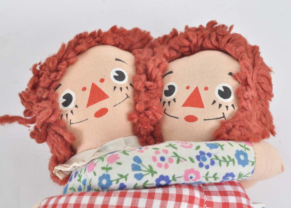 Embracing Raggedy Ann and Andy
