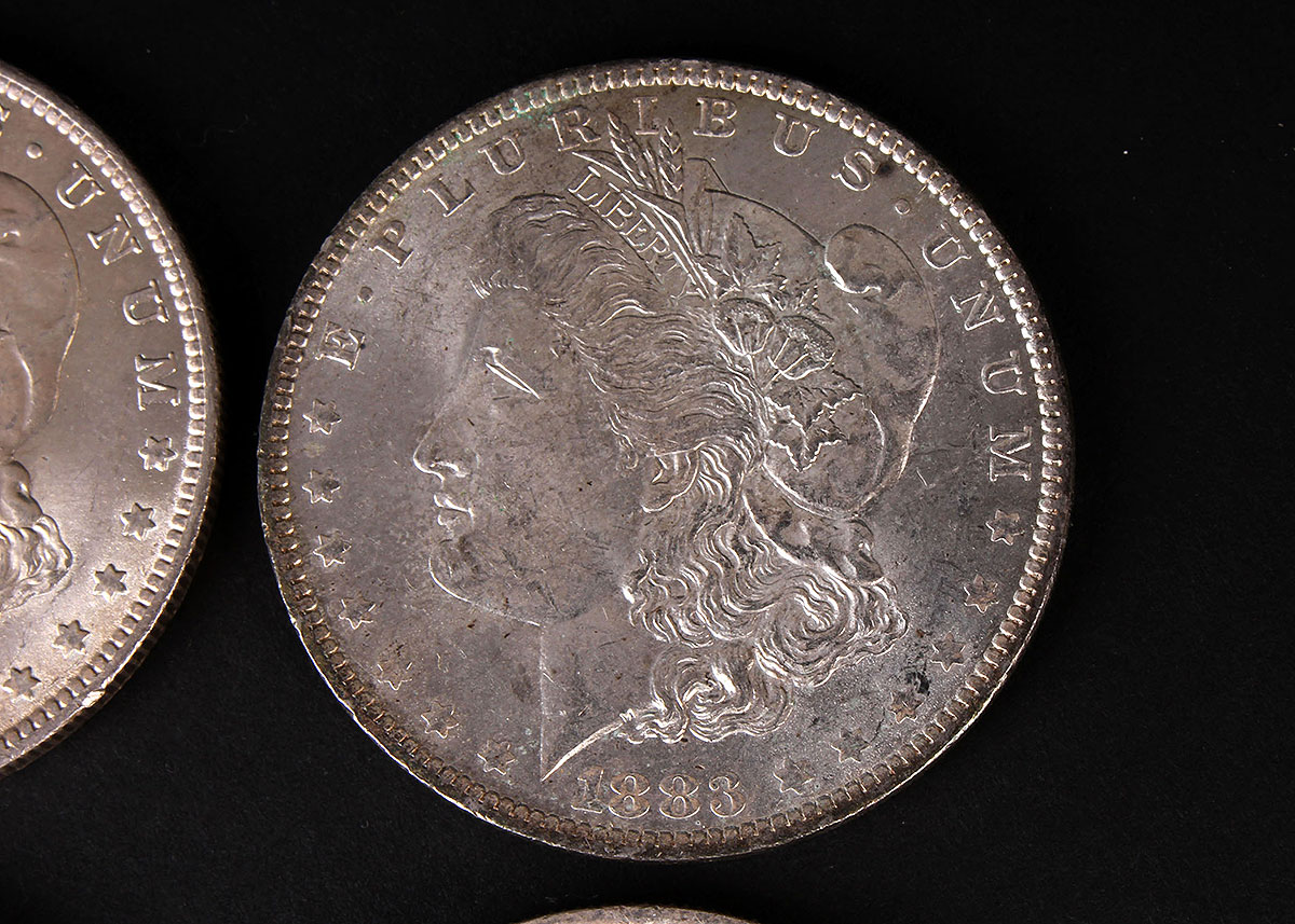 Four 1883-O Morgan Silver Dollars