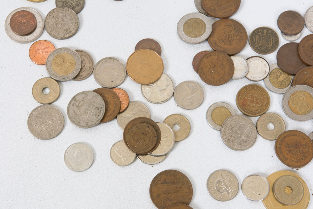 Collection of Mexican and Canadian Coins in a Glass Vase