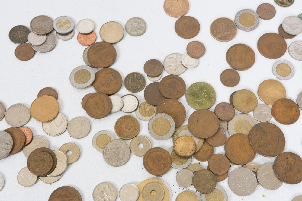Collection of Mexican and Canadian Coins in a Glass Vase