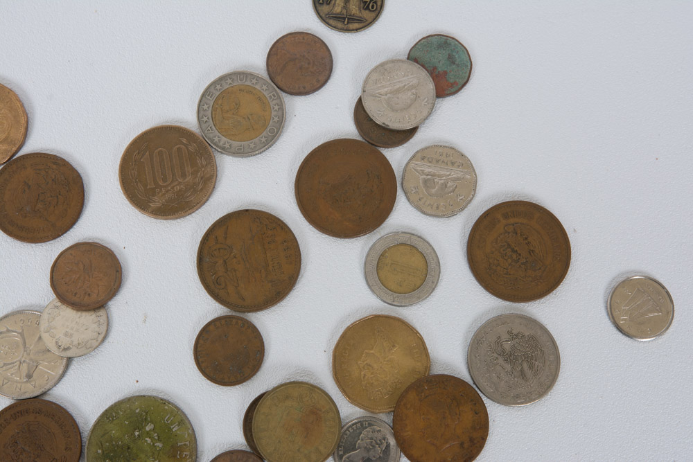Collection of Mexican and Canadian Coins in a Glass Vase