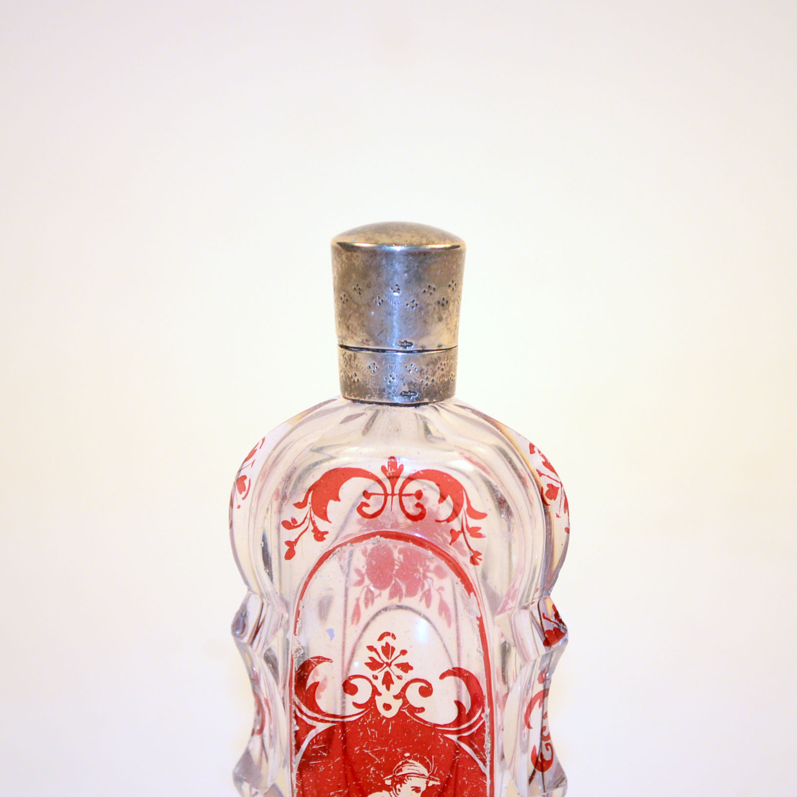 Antique Glass Perfume Bottle with Red Accents and Metal Cap