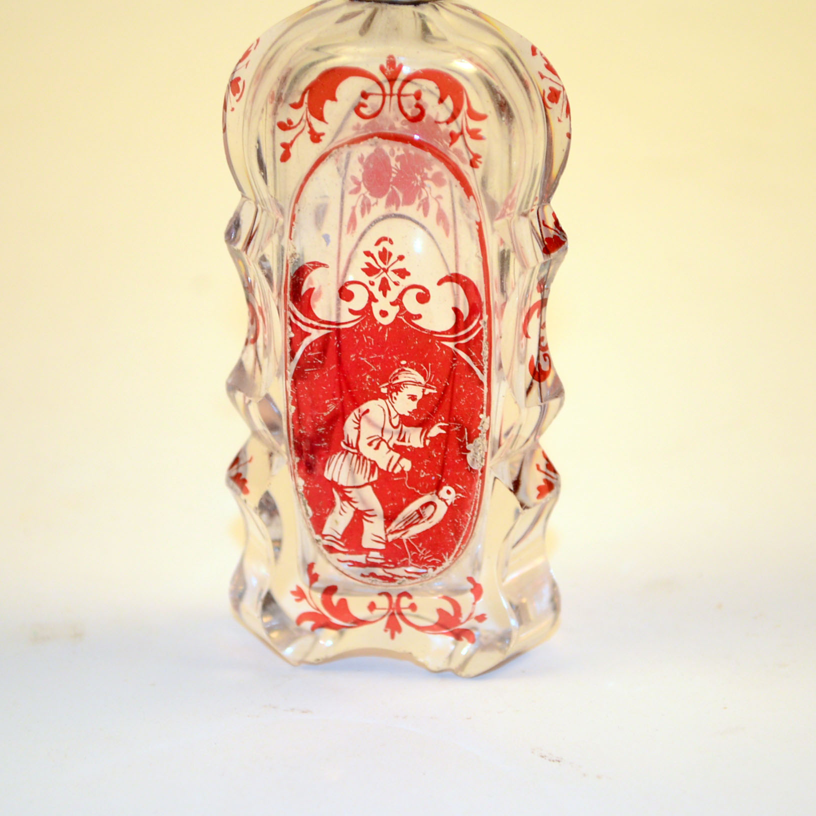 Antique Glass Perfume Bottle with Red Accents and Metal Cap