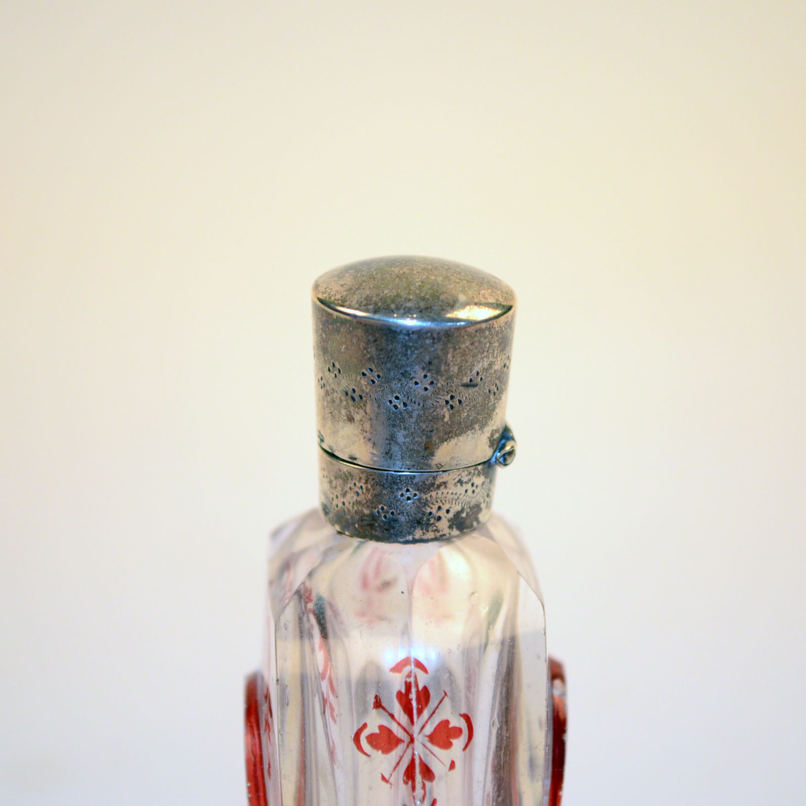 Antique Glass Perfume Bottle with Red Accents and Metal Cap