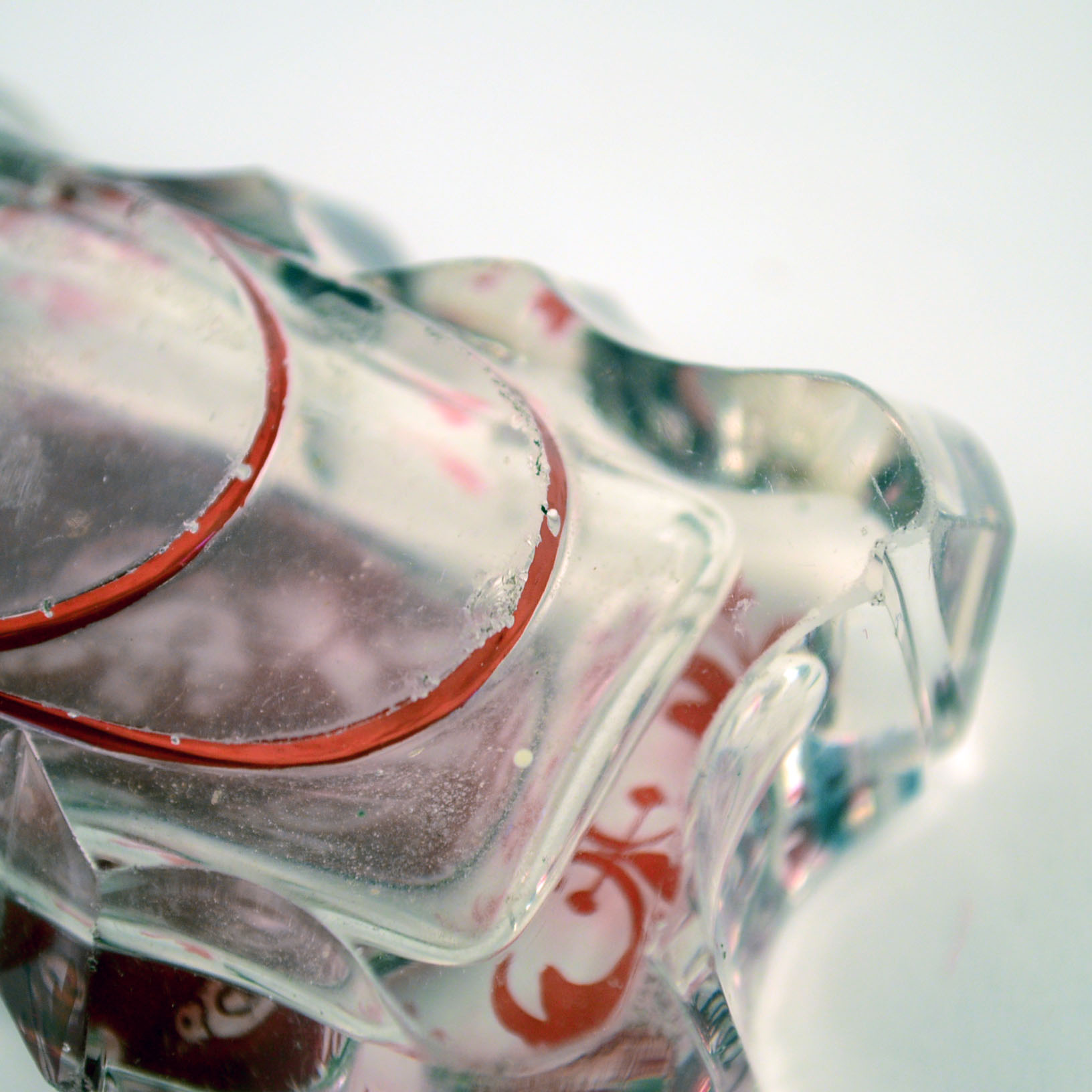 Antique Glass Perfume Bottle with Red Accents and Metal Cap