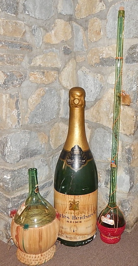 Two Glass Wine Bottles and Large  Plastic Champagne Bottle